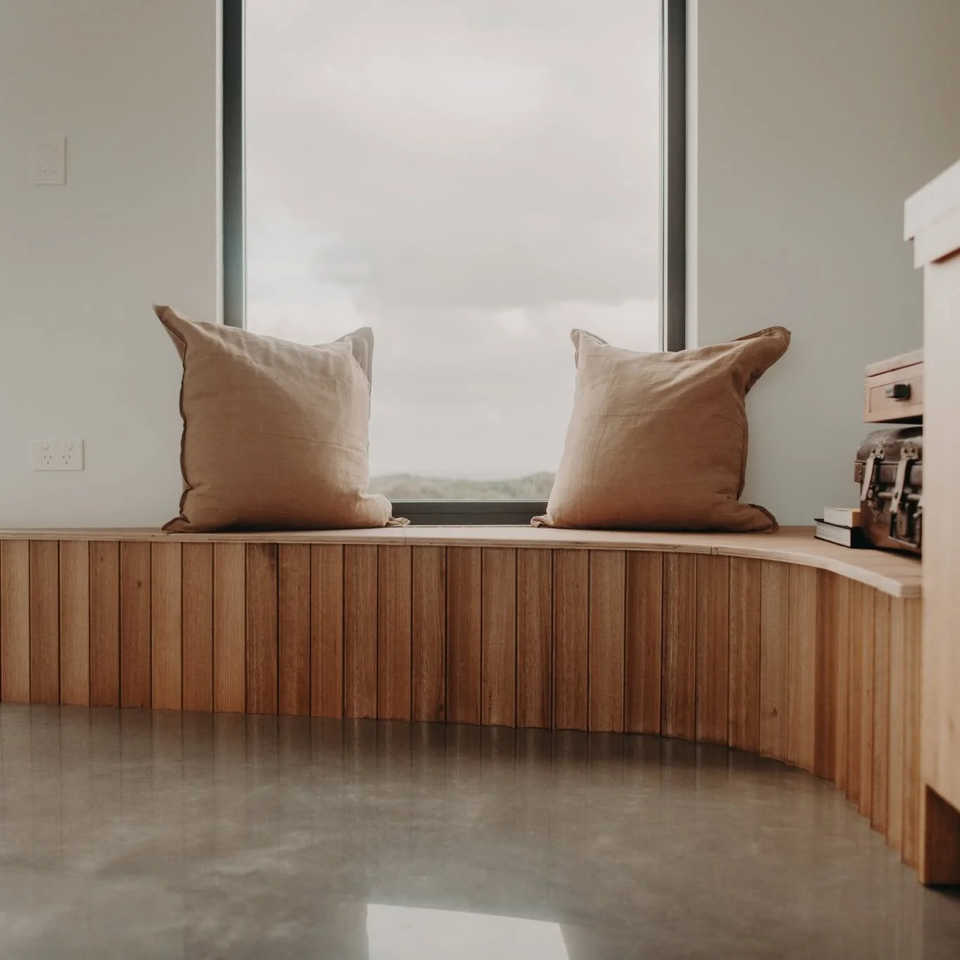 A quiet corner to pause ☁️ This curved fluted timber seat is the perfect spot to sit, read, and take in the view across the farmland.

#habitatprojects #customjoinery #nooks #builtinseating #windowseat #australiandesign #TimberDetails #interiordesign
