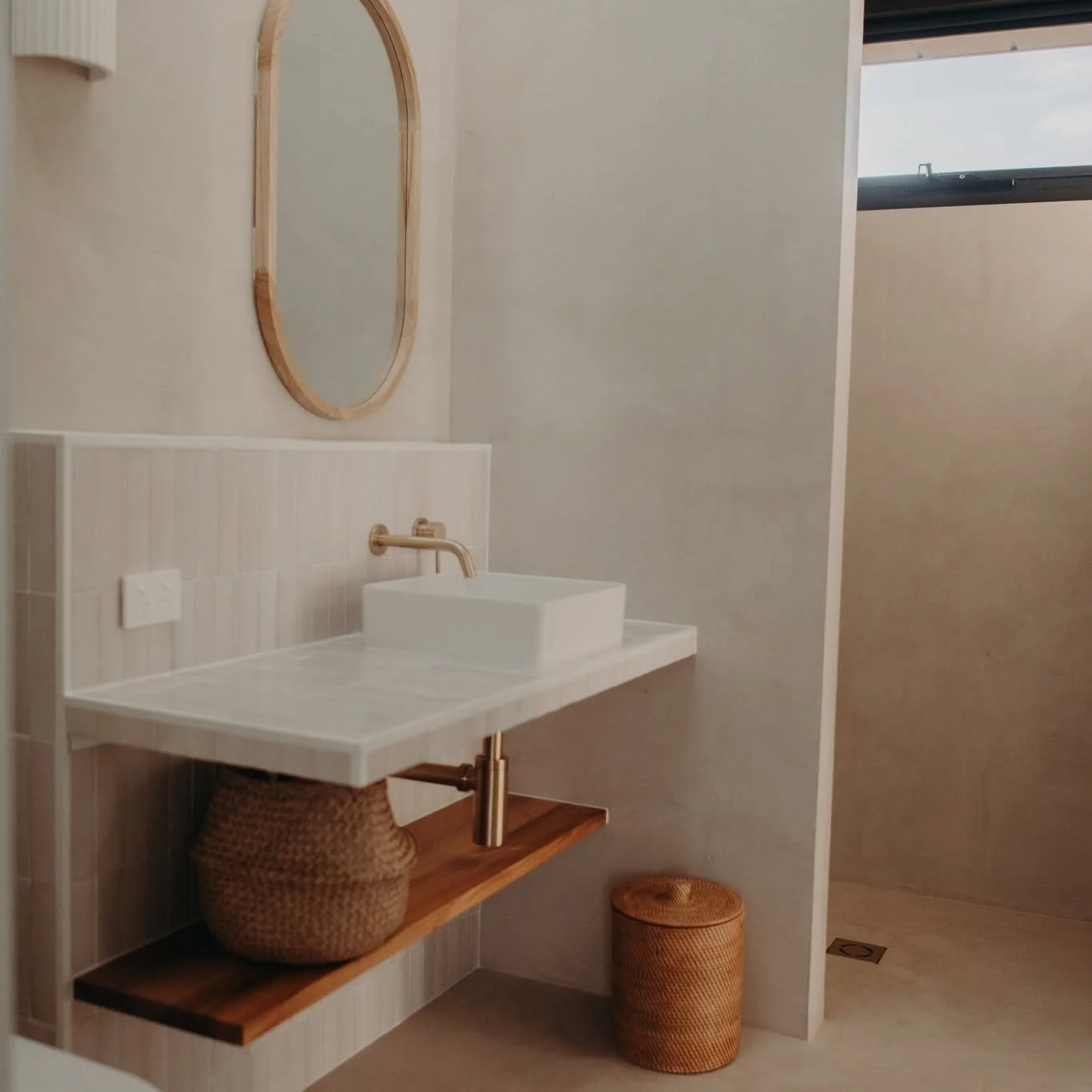 This plastered finish is suitable for wet areas, is highly durable and also adds a soft, natural look. Floating timber shelves provide useful storage, and handmade tiles bring a bit of texture and interest.

#HabitatProjects  #HabitatatLightsBeach #B