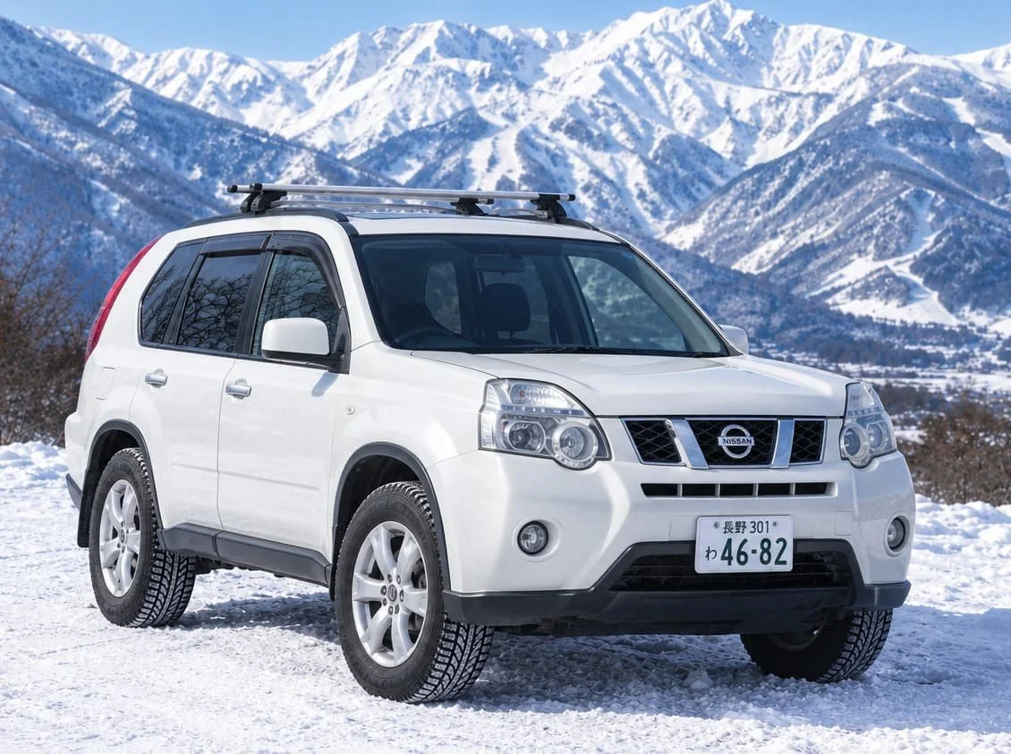 White Nissan X-Trail rental car parked on Japanese snow