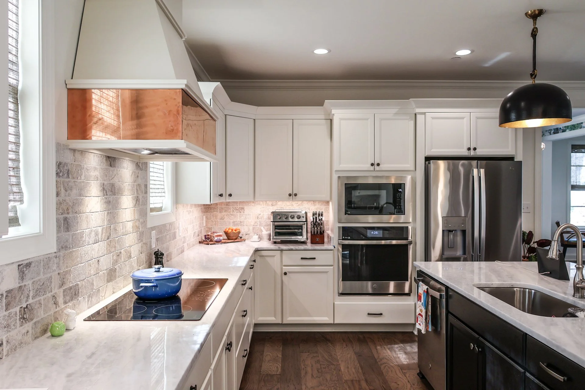 copper accented kitchen exhaust and under cabinet lights