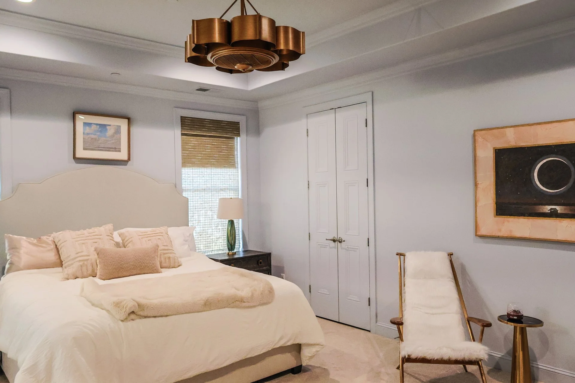 master bedroom featuring custom lighitng and tray ceilings