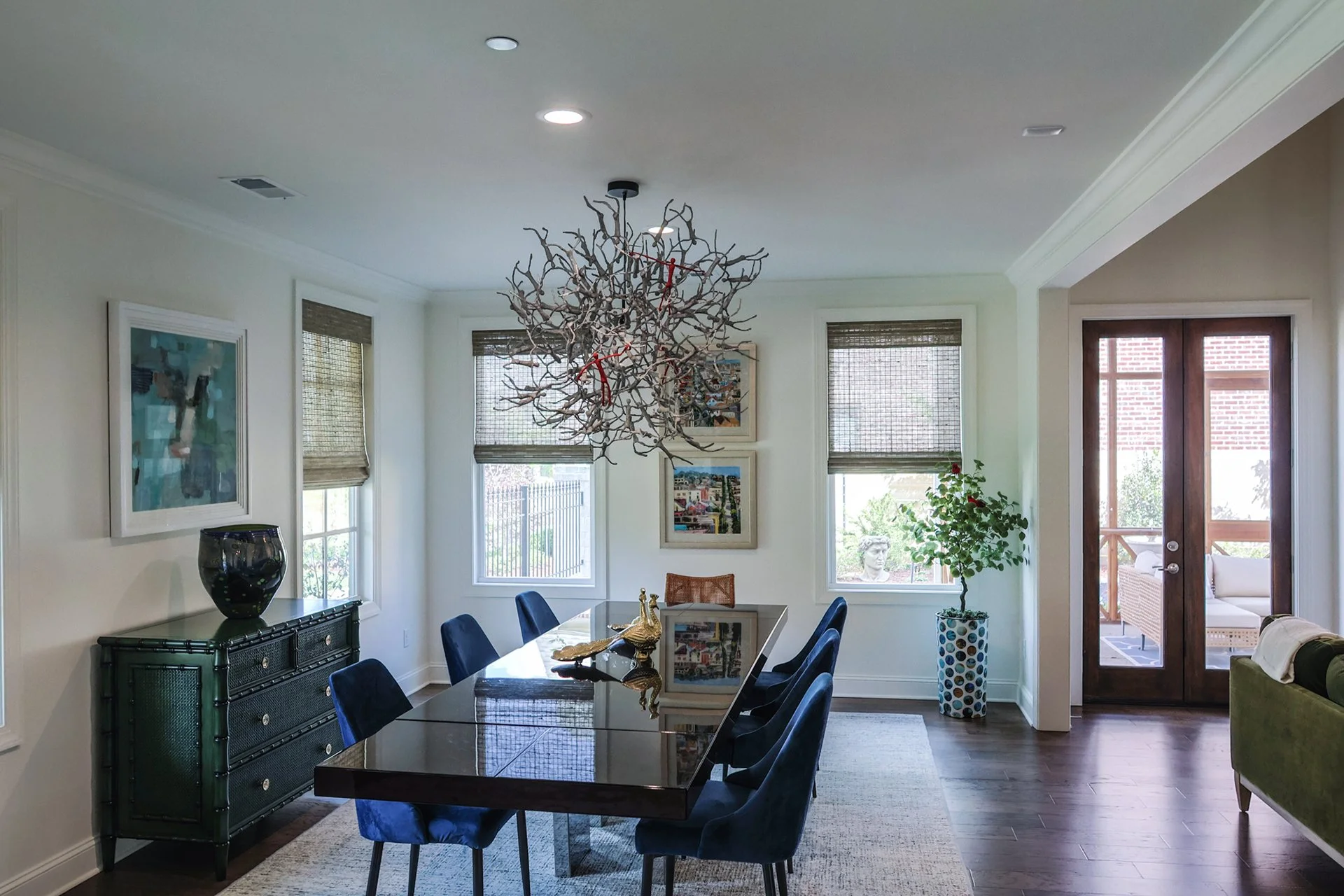 relaxing blue dining room with modern artistic lighting centerpiece