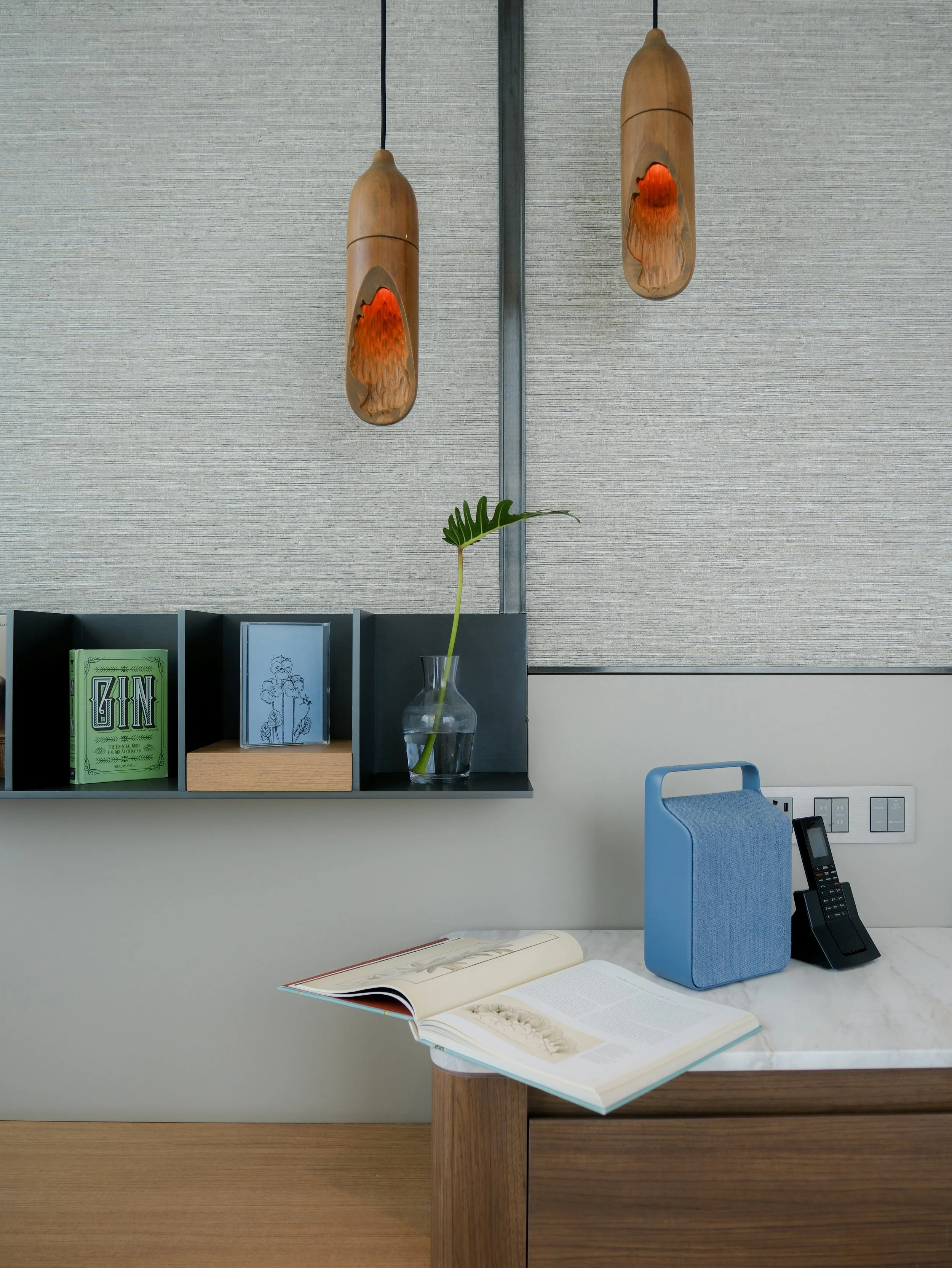 Kimpton Maa Lai Bangkok hotel bedside detail with amenities and folded towel on nightstand — luxury hotel interior photography