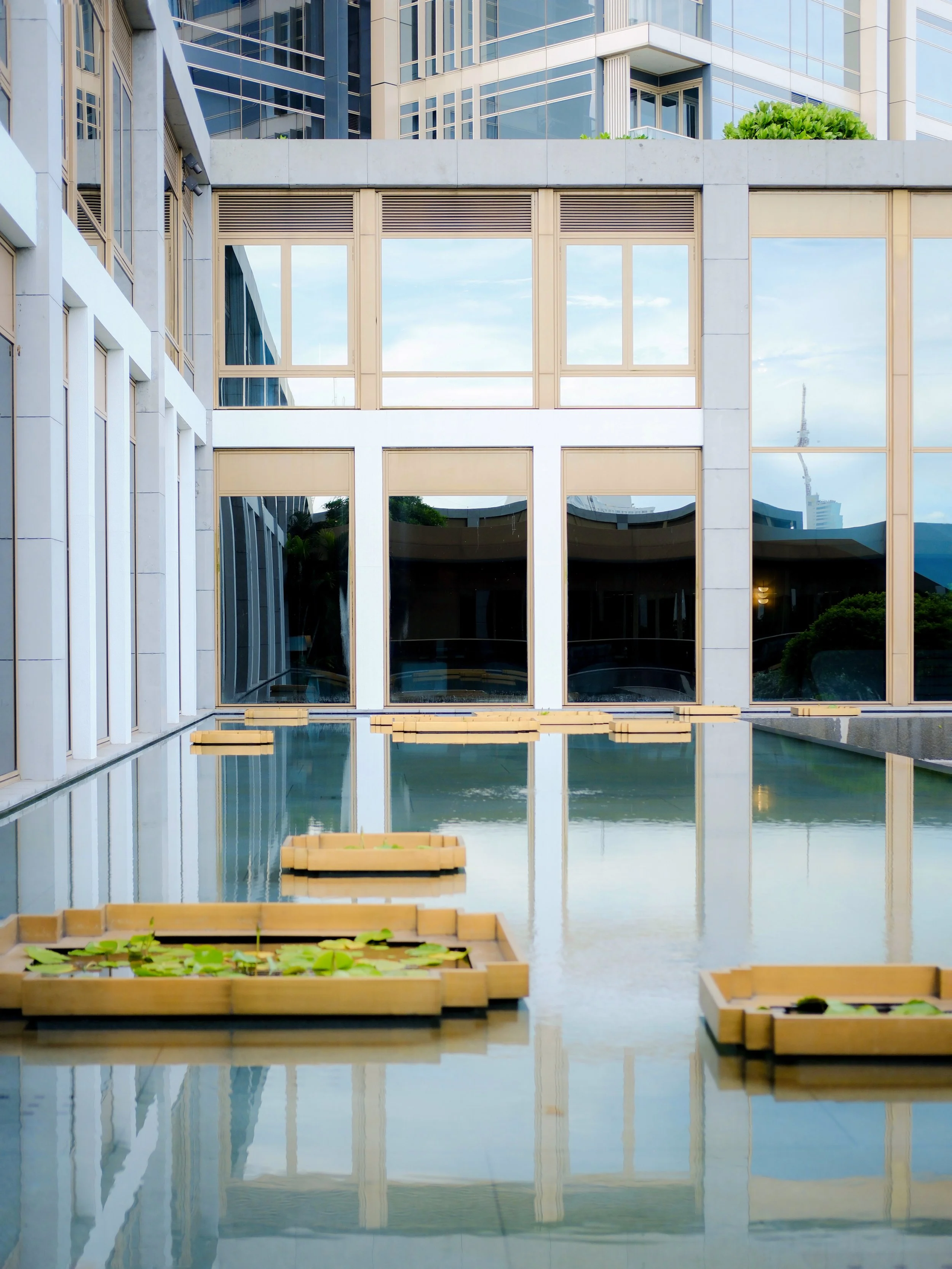 Capella Bangkok hotel exterior reflected in a lily pond — luxury hotel architectural photography
