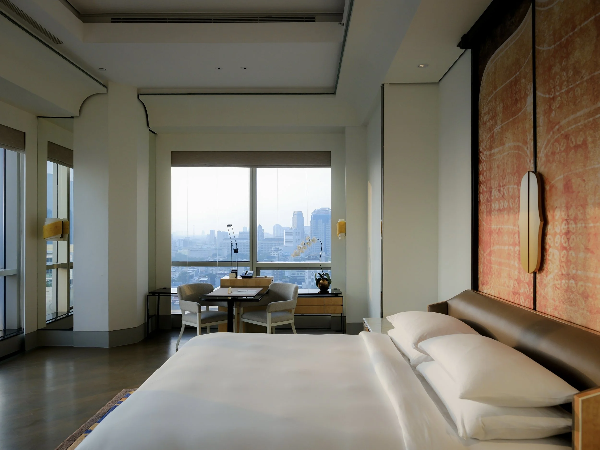 Keraton at The Plaza Jakarta luxury hotel room with city skyline view through floor-to-ceiling window — hotel photography by Dillon Atsiil, Jakarta 2026