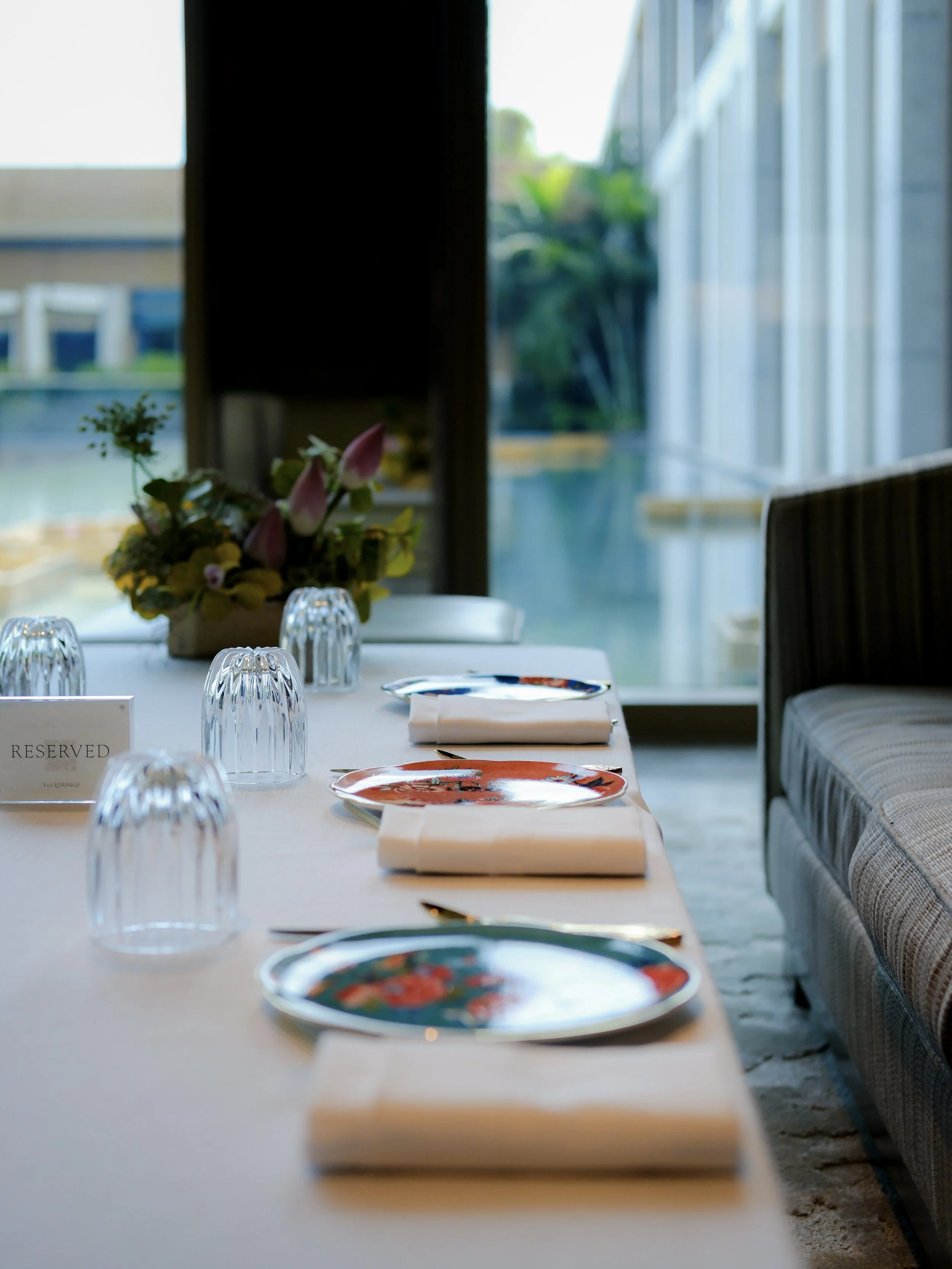 Capella Bangkok hotel restaurant table setting with fresh flowers — luxury hotel dining photography