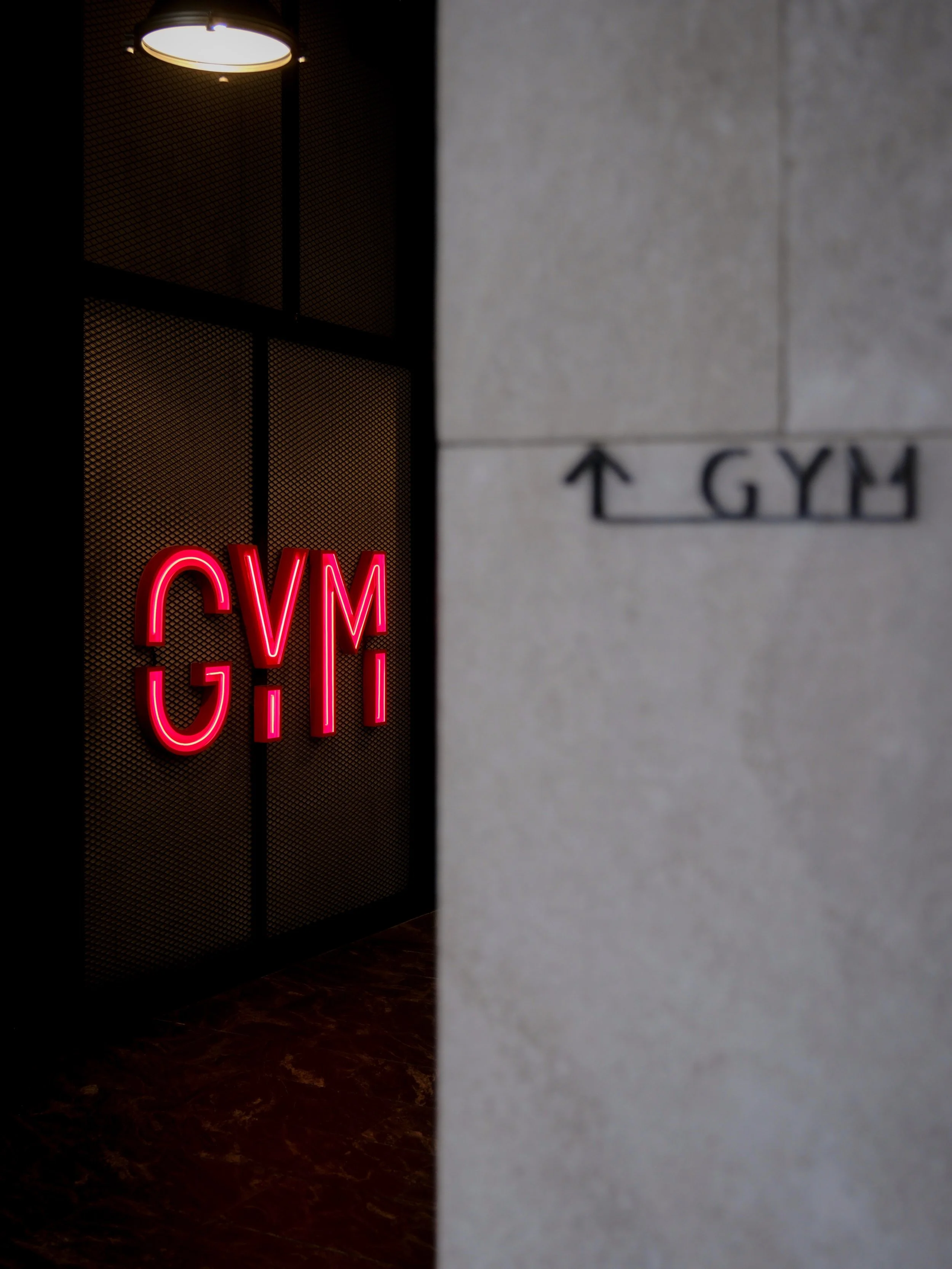 Kimpton Maa Lai Bangkok gym entrance with red neon GYM signage — hotel facilities photography by Dillon Atsiil
