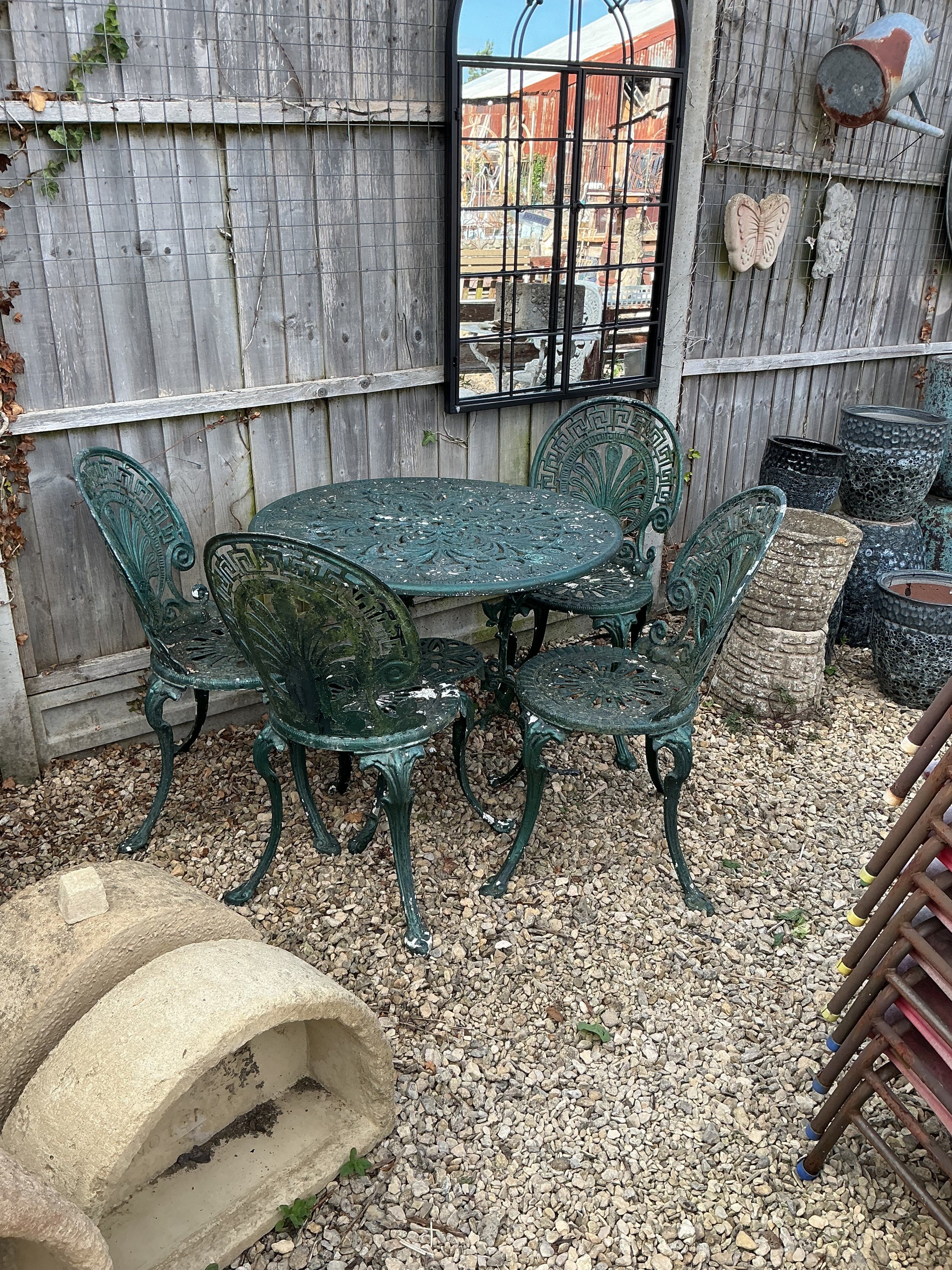 Green aluminium table and four chairs.