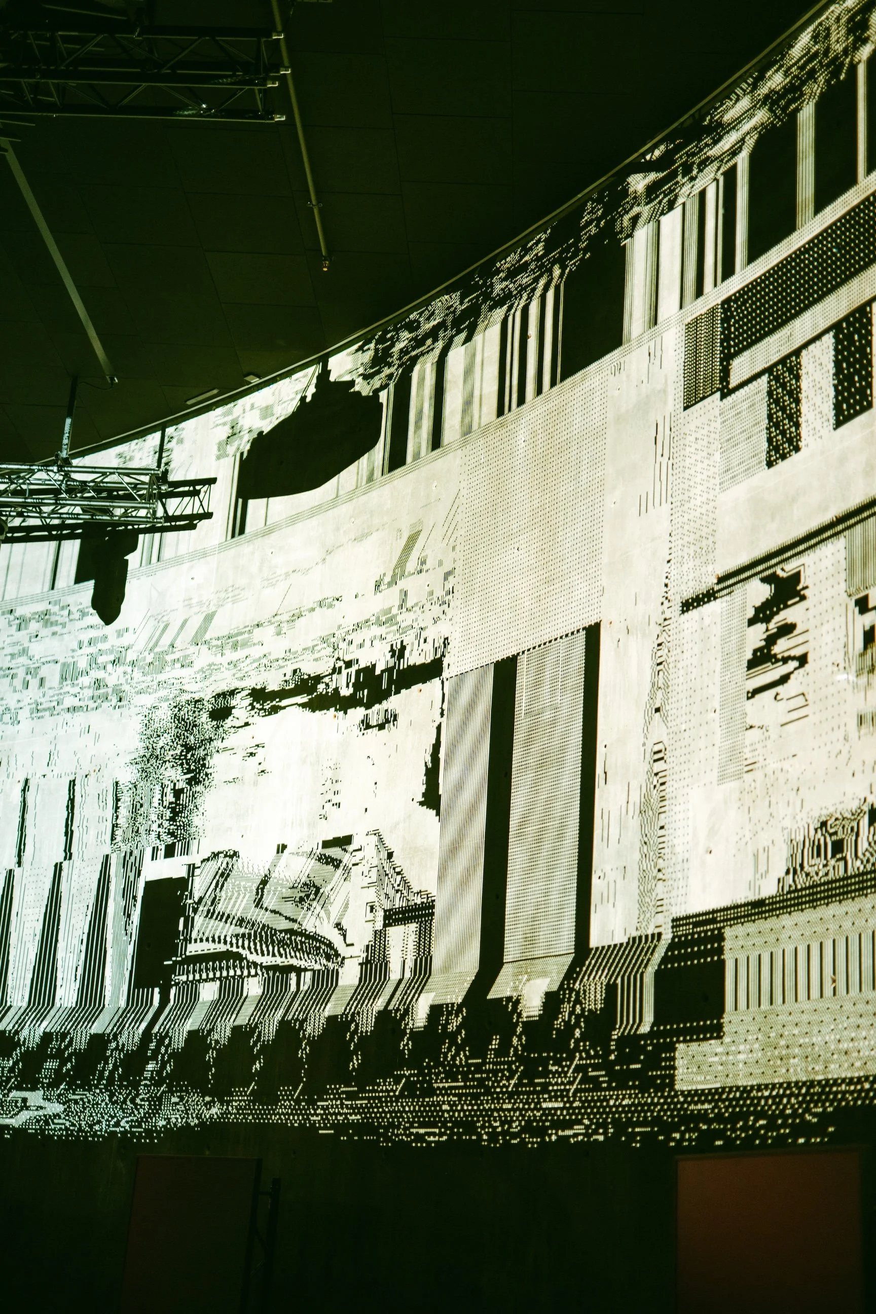 Digital glitch art installation with pixelated black and white geometric shapes and patterns, includes a structure resembling a ship or submarine silhouette in the center