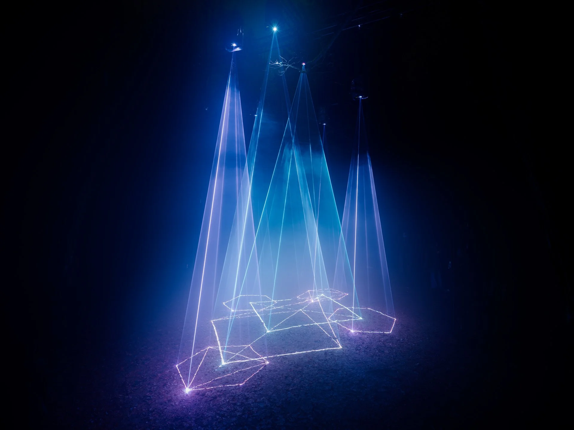 Cathedral of Ego: Light, Code, and Transcendence  MAXIME PLESCIA-BÜSCHI AND BJØRN STAAL  x COLLECTIVE OSLO Laser lights creating geometric patterns and sharp lines in a dark space.