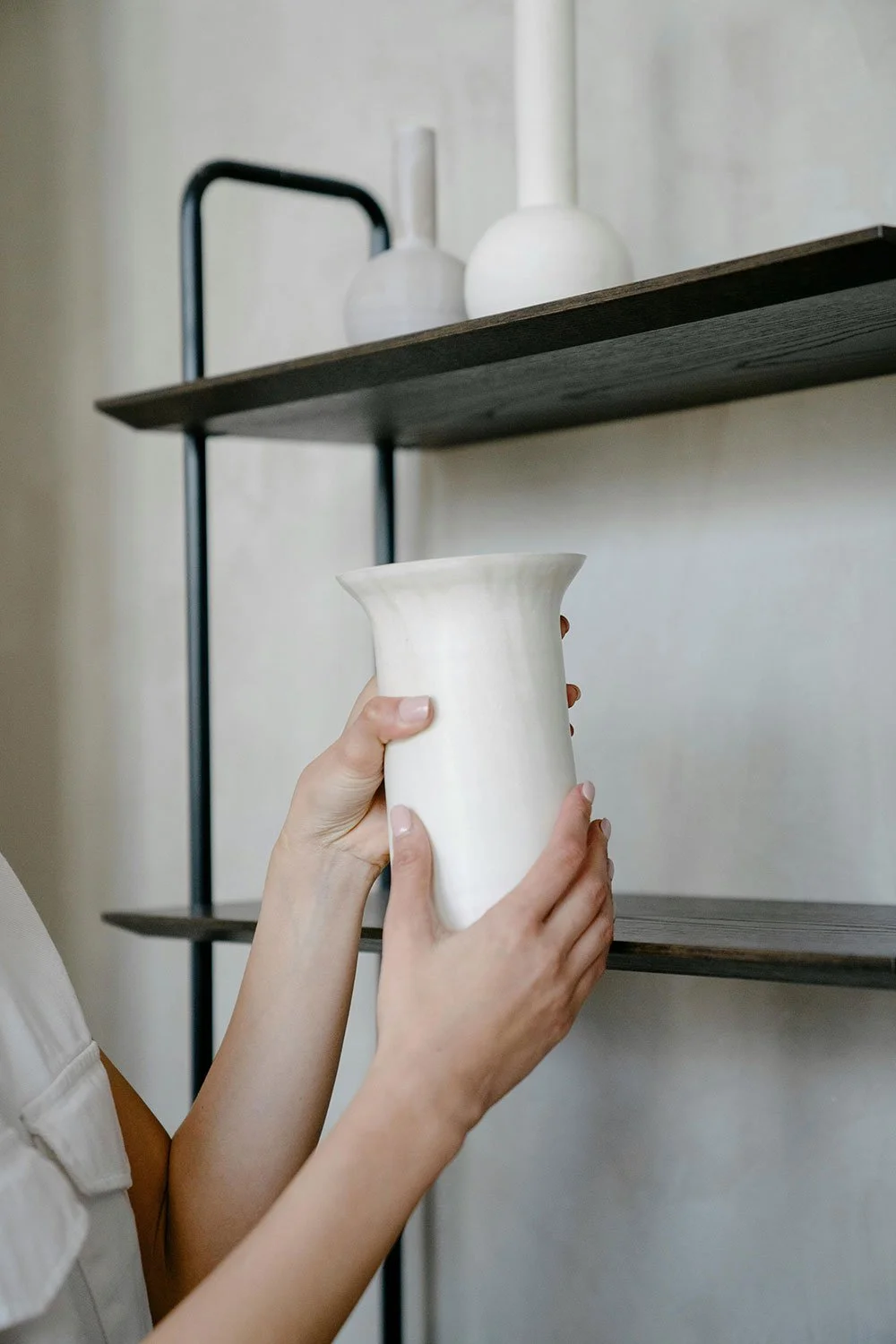 interior designer hands ceramic vase