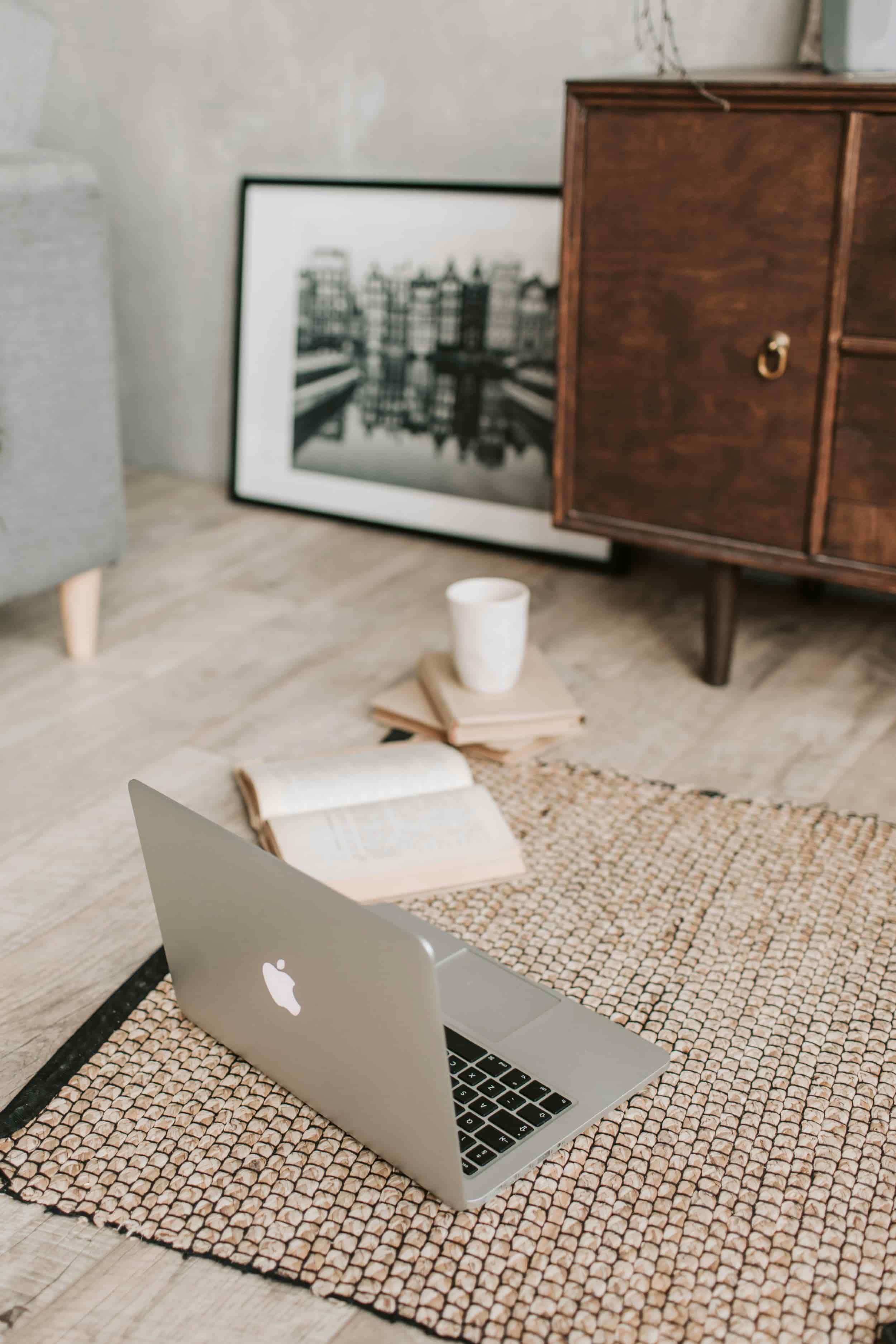 laptop and book on living room floor