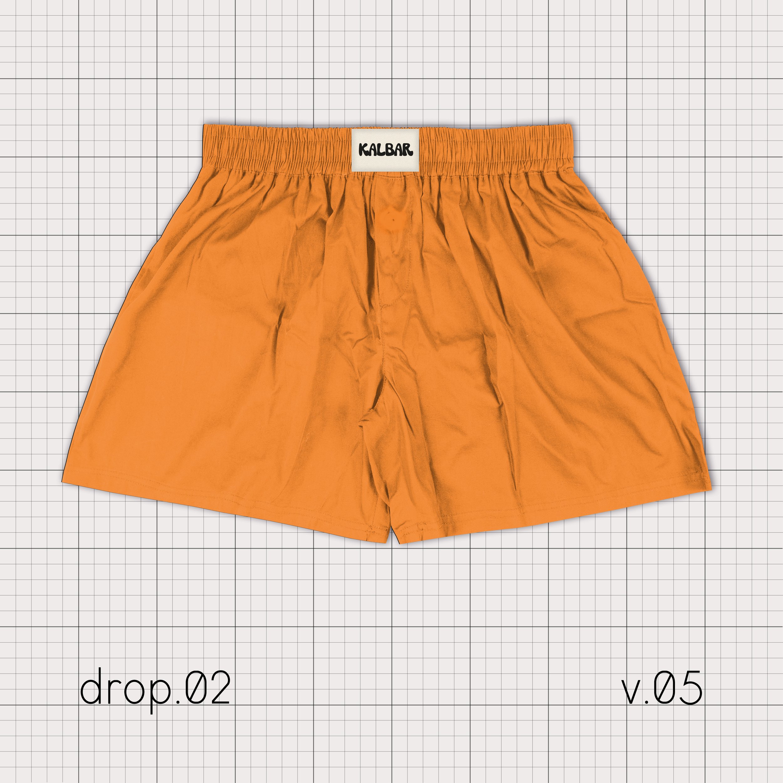 Un caleçon orange avec élastique à la taille, sur un fond quadrillé. "Kalbar" est inscrit sur l'étiquette.