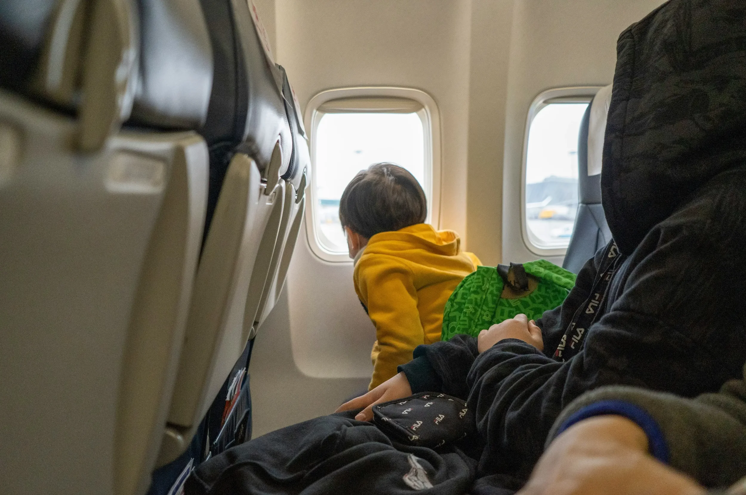 Child looking out airplane window