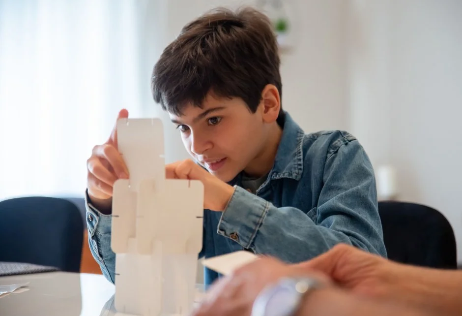Image of a young boy stacking cards.