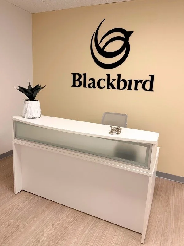 Cheerful white desk at reception area in the Blackbird Health Mount Laurel NJ clinc.
