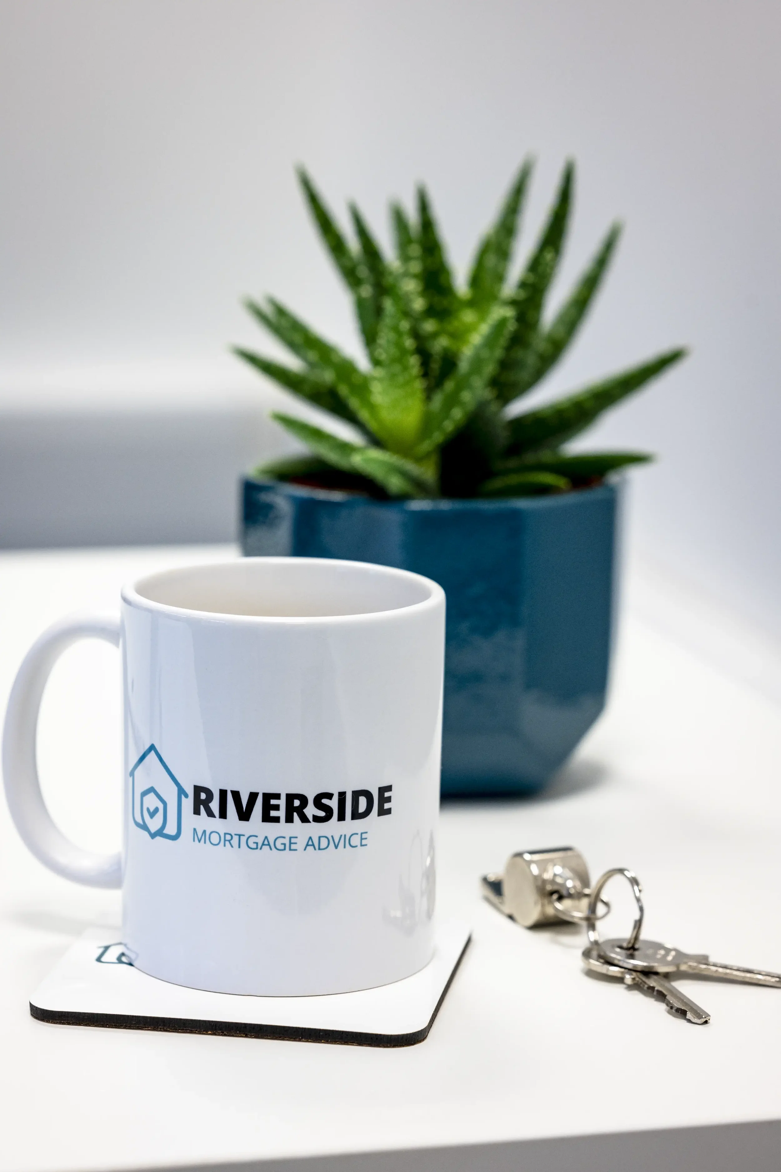 Picture of a mug and plant for Riverside Mortgage Advice.
