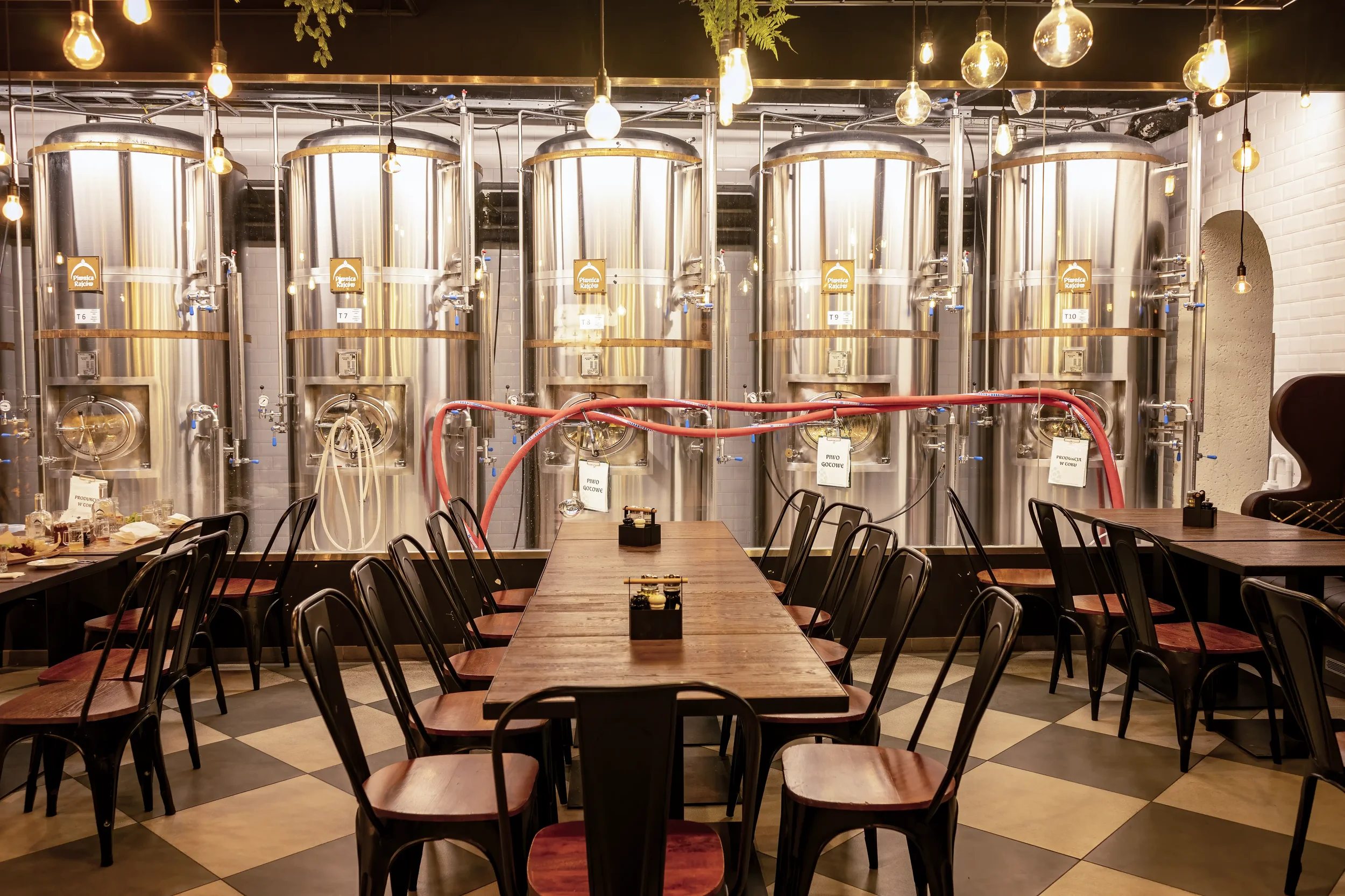 Colour photograph of the interior of a micro-brewery with its fermentation vessels inside a pub