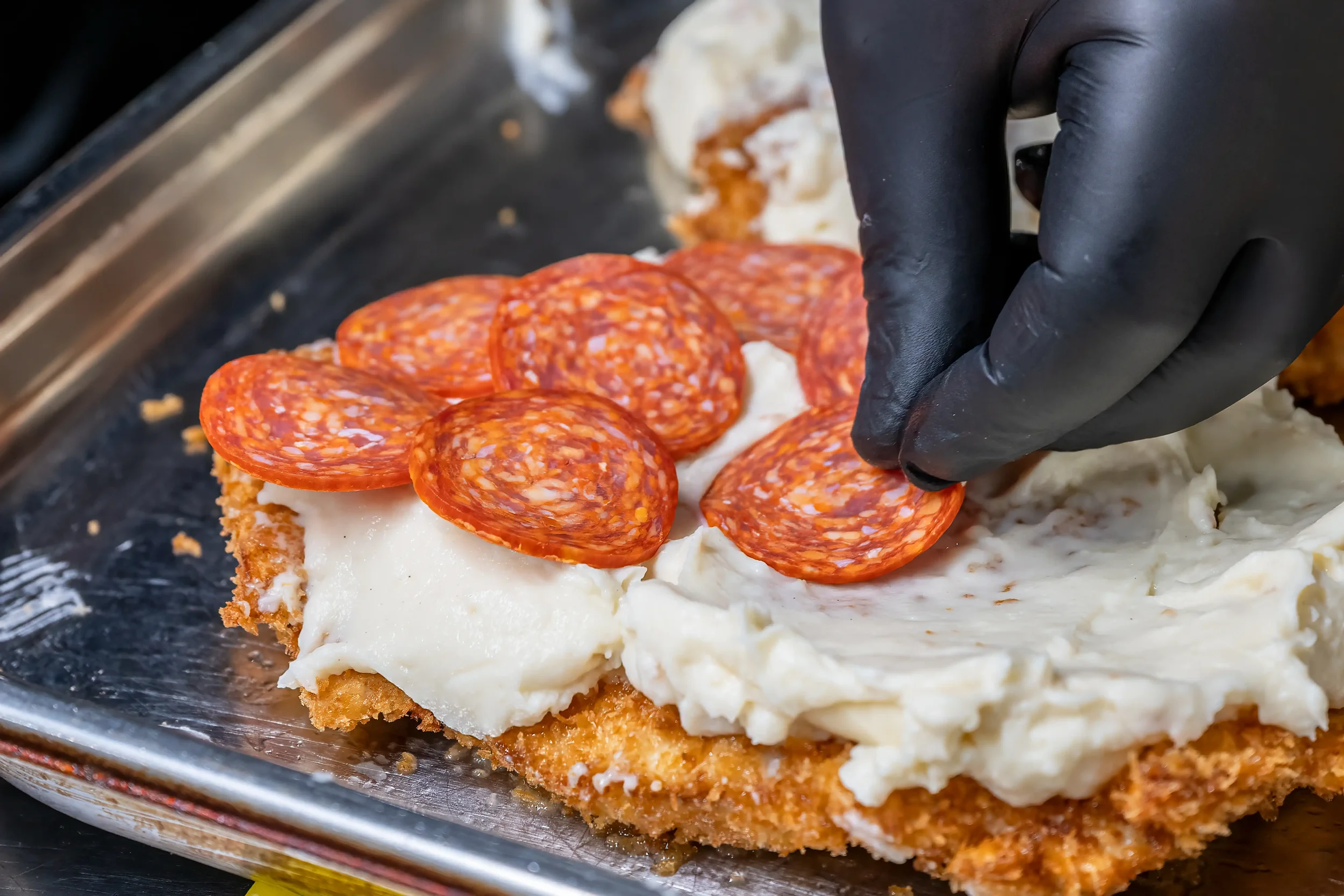 Colour close up photograph of a meal being prepared in a commercial kitchen