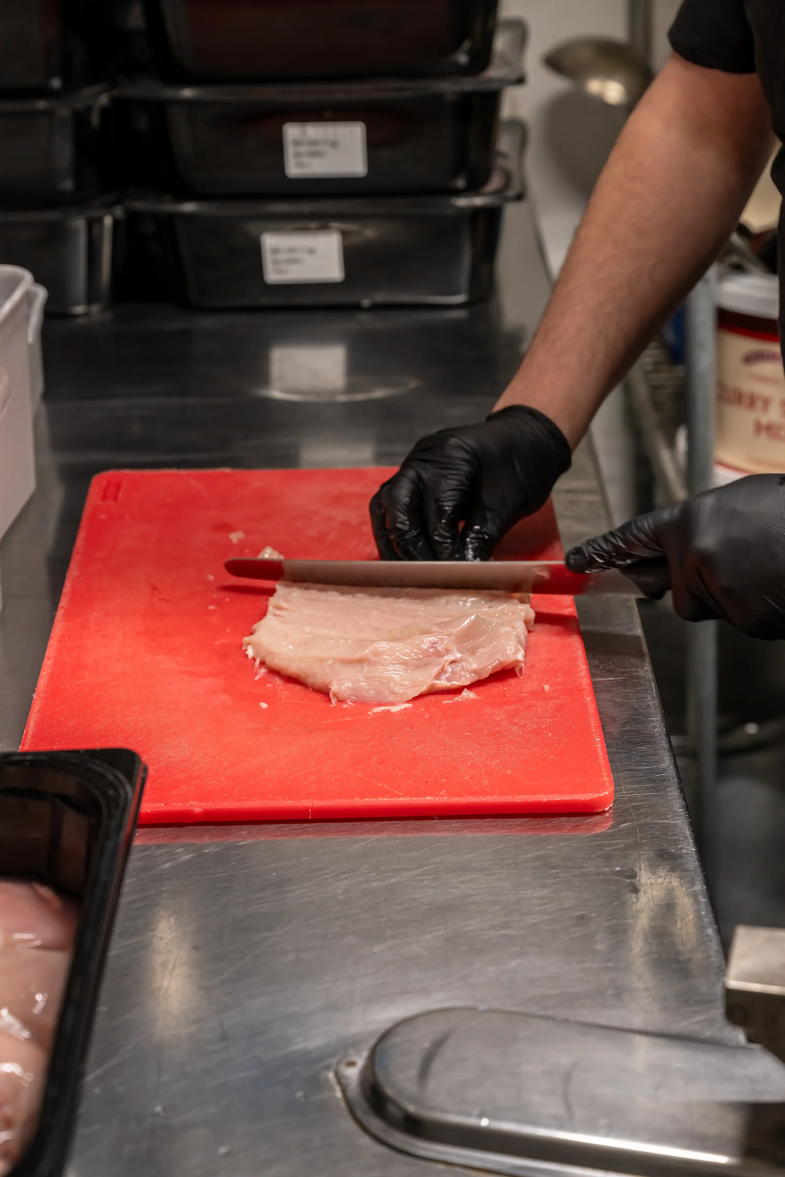 Colour photograph of chicken being prepared for a meal in a commercial kitchen