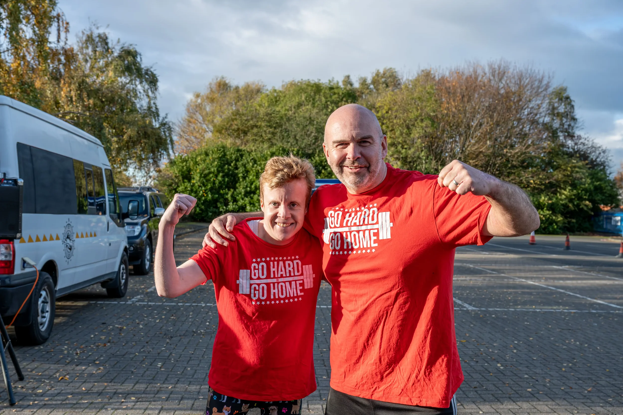 Colour photograph of a man and a woman standing in front of an ambulance, posing for the picture at the start of a charity fund-raising event for Tiny Lives Charity.