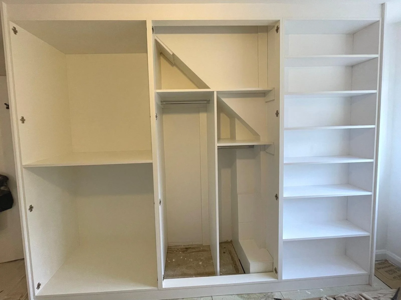 fitted wardrobes. end panel. book shelves. bespoke wardrobes. Bella Richmond. white. Funtington. Chichester