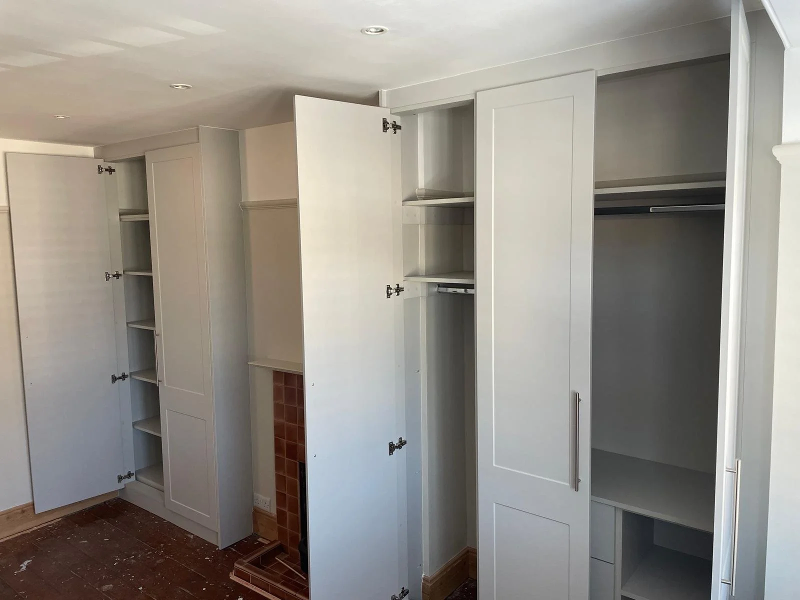 alcove in bedroom. fitted wardrobes. fireplace. chimney breast. bella Richmond. white bespoke wardrobes. front framed. Chichester