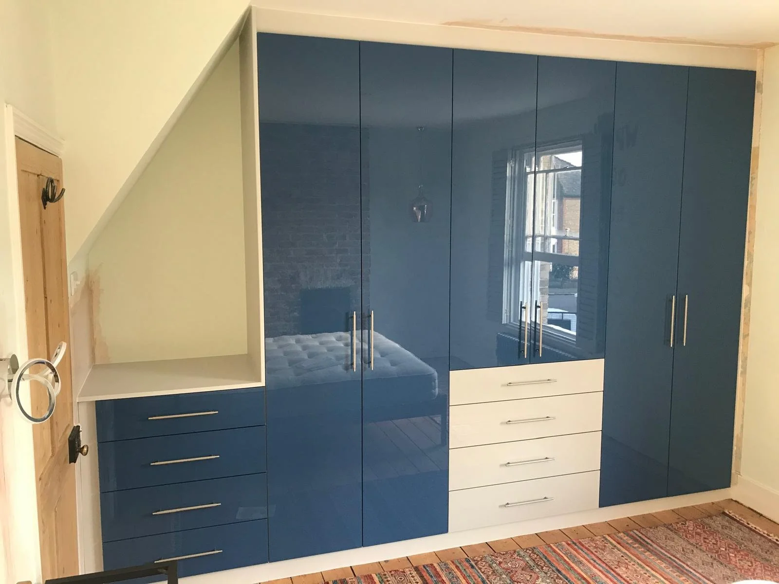 glossy blue. fitted wardrobes. bedroom furniture. Zurfiz Baltic ultra gloss blue. grey. side mount pull out shoe rack. Blum Legrabox drawers. internal mirror. Caledonian Road. Chichester. West Sussex