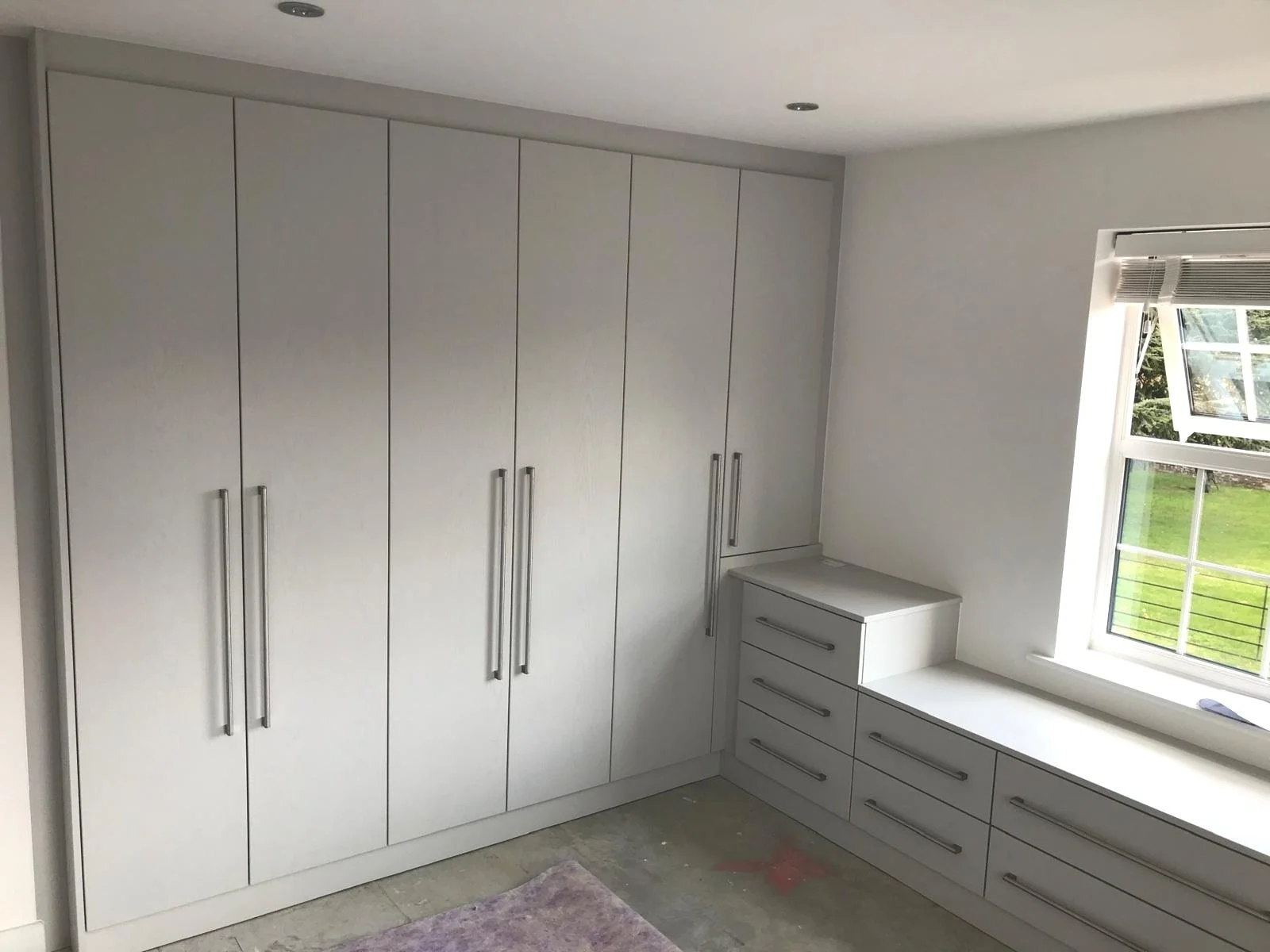 fitted wardrobes. fitted bedroom. Bella. stable door. grey. long bar handles. window seat. drawers. Bella VENICE. Petersfield. Hampshire
