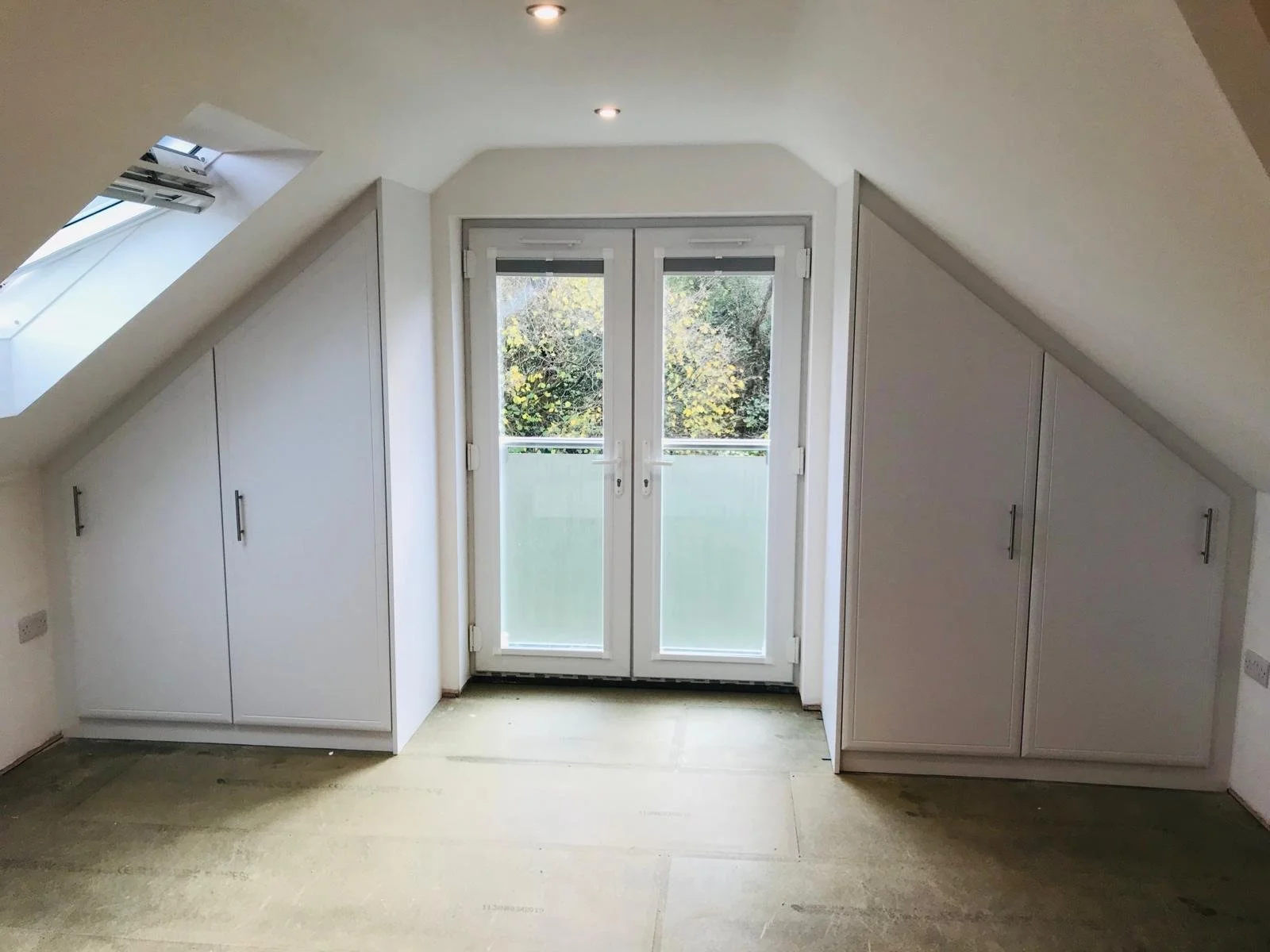 attic bedroom. sloping ceiling. bespoke fitted wardrobes. angle ceiling. made to measure. bella euroline. white. hinged angle doors. internal mirror. Chidham. Chichester. West Sussex