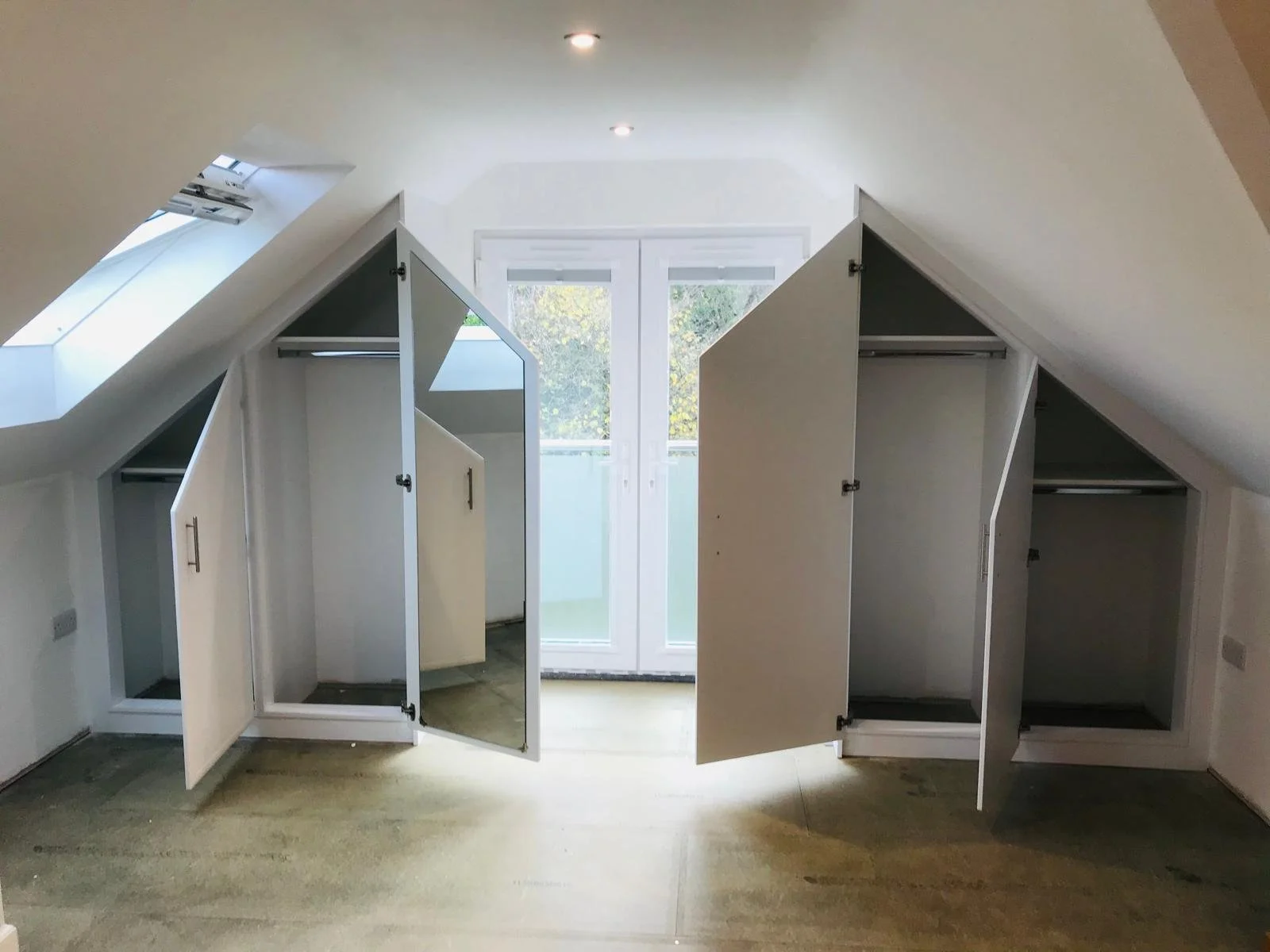 attic bedroom. sloping ceiling. bespoke fitted wardrobes. angle ceiling. made to measure. bella euroline. white. hinged angle doors. internal mirror. Chidham. Chichester. West Sussex