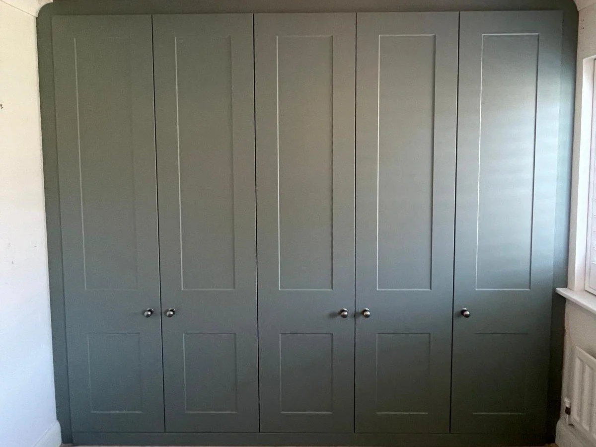 builders wardrobes. wasted storage. rip out hinged doors. remove stud wall. replcement doors. plaster walls. new bella Carrick. sage green. fitted wardrobes. Chichester. West Sussex