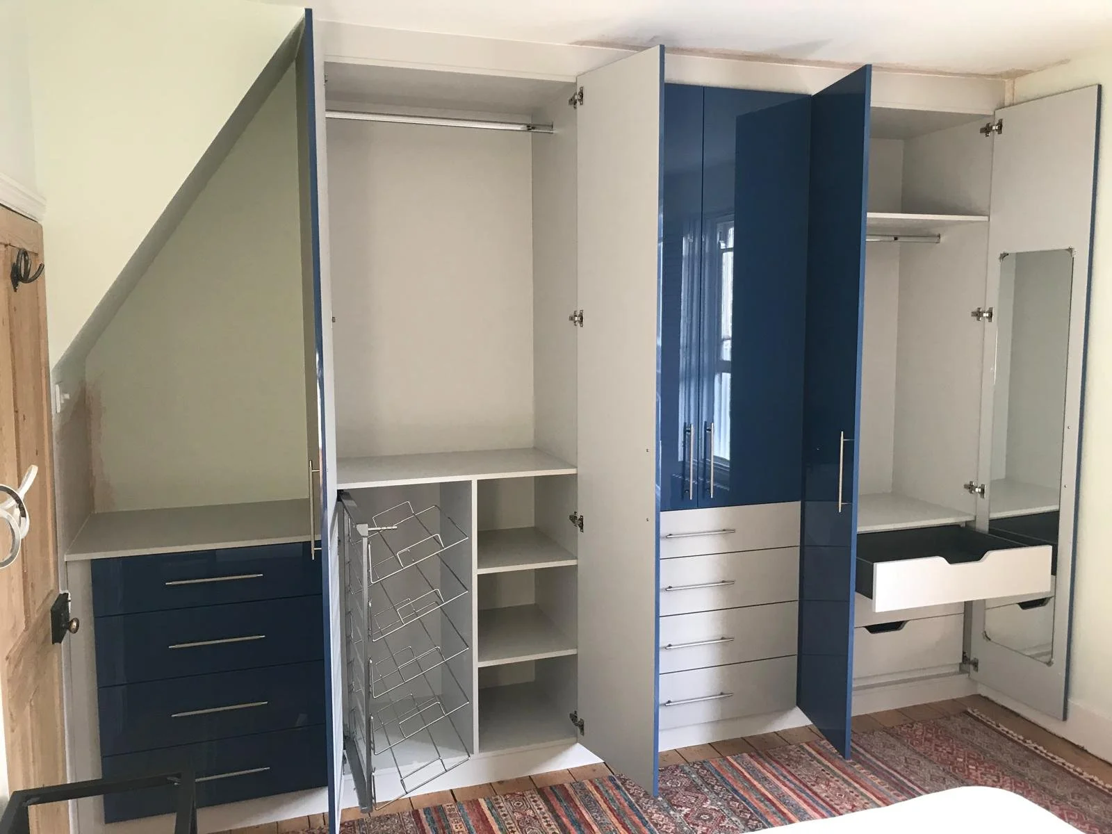 glossy blue. fitted wardrobes. bedroom furniture. Zurfiz Baltic ultra gloss blue. grey. side mount pull out shoe rack. Blum Legrabox drawers. internal mirror. Caledonian Road. Chichester. West Sussex