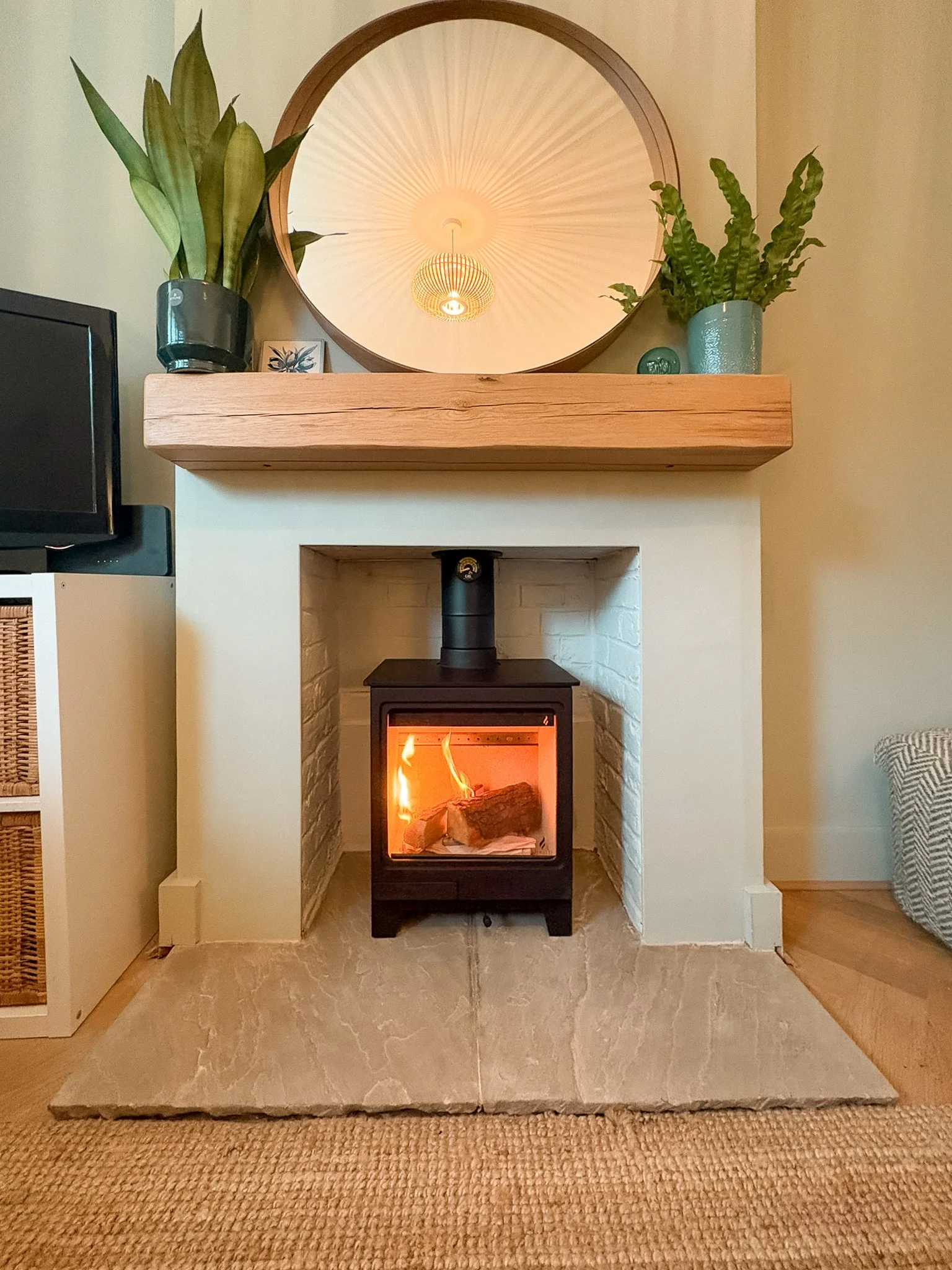Allure 4 Stove, Light Coloured Hearth and Floating Beam installed in painted brick chimney.