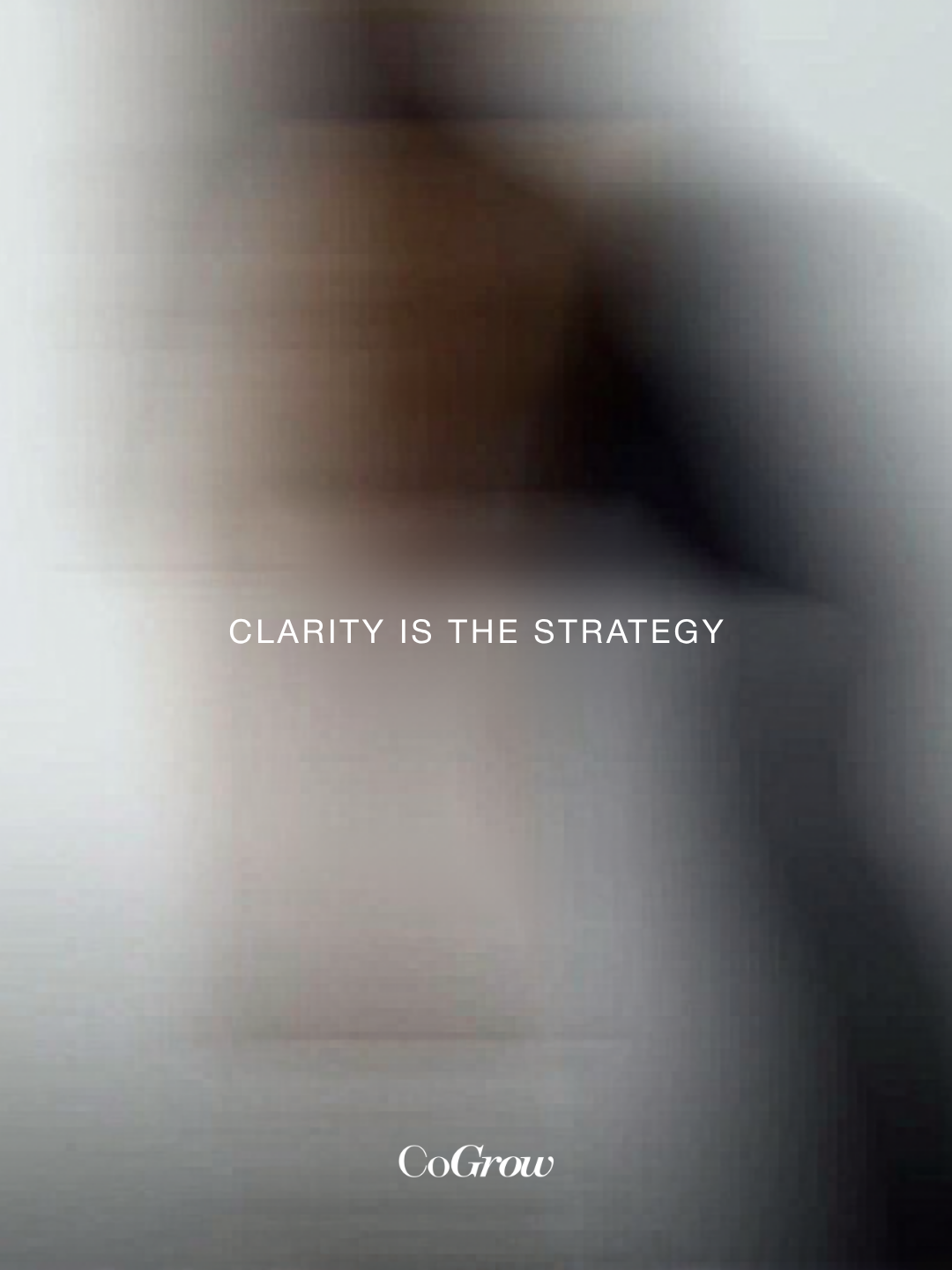 Blurred background with the text 'Clarity is the Strategy' and the brand name 'CoGrow' at the bottom.