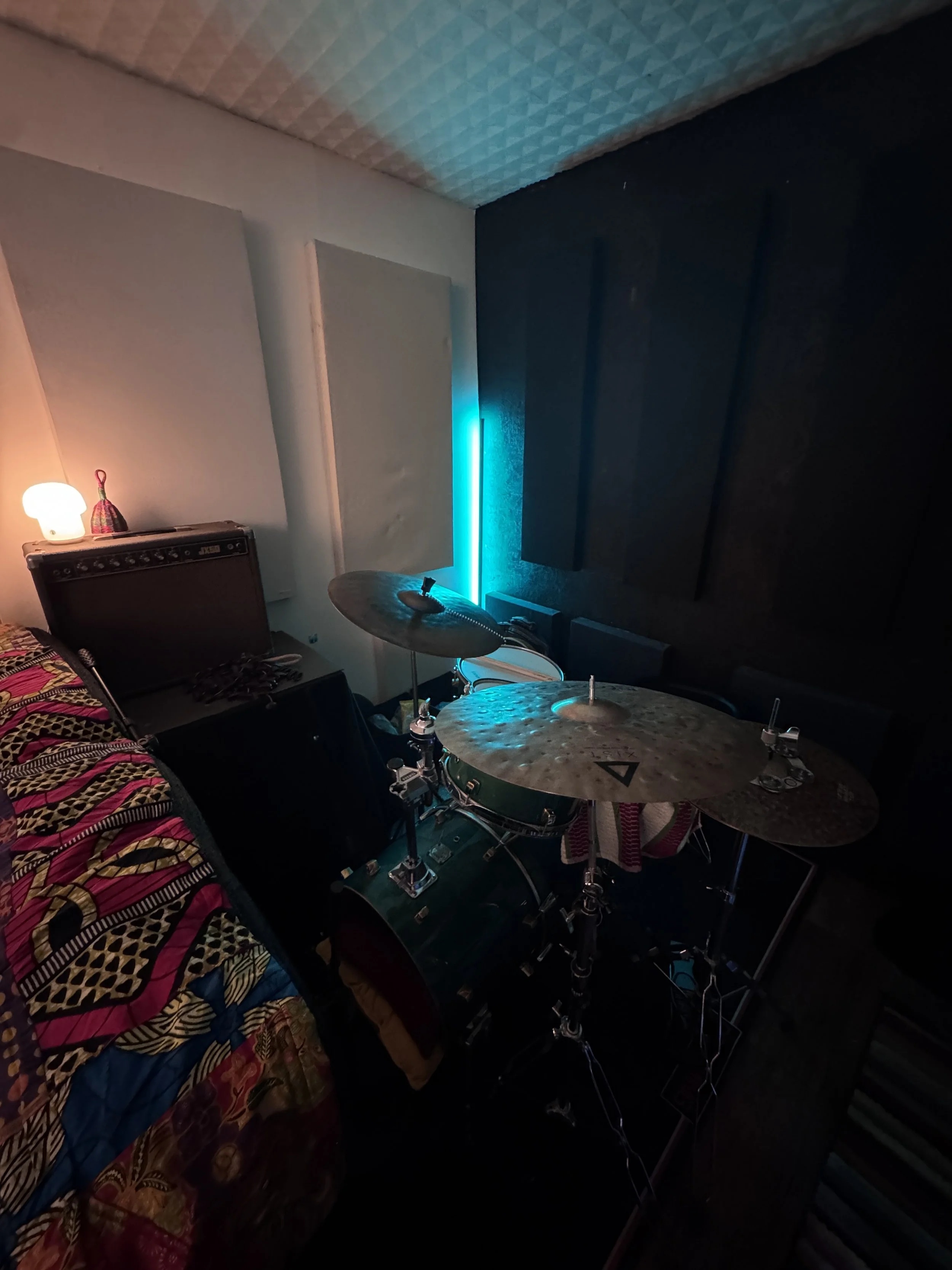 Drum recording area at The Low Studios lit with soft ambient studio lighting.