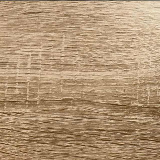 Close-up of a wooden surface showing the grain and texture of the wood.