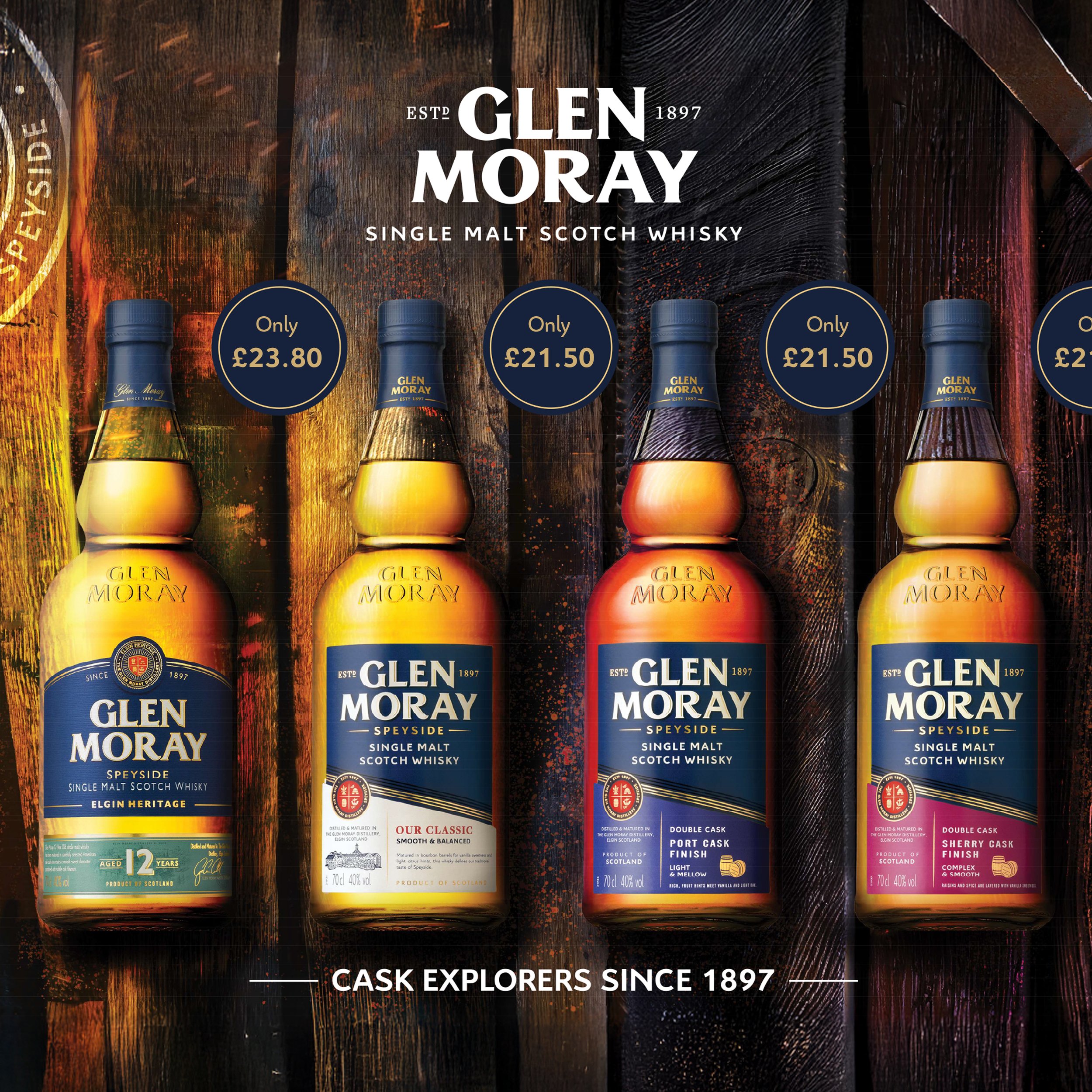Four bottles of Glen Moray single malt Scotch whisky displayed on a wooden surface, featuring different labels and price tags in pounds. Text states "Cask Explorers Since 1897."