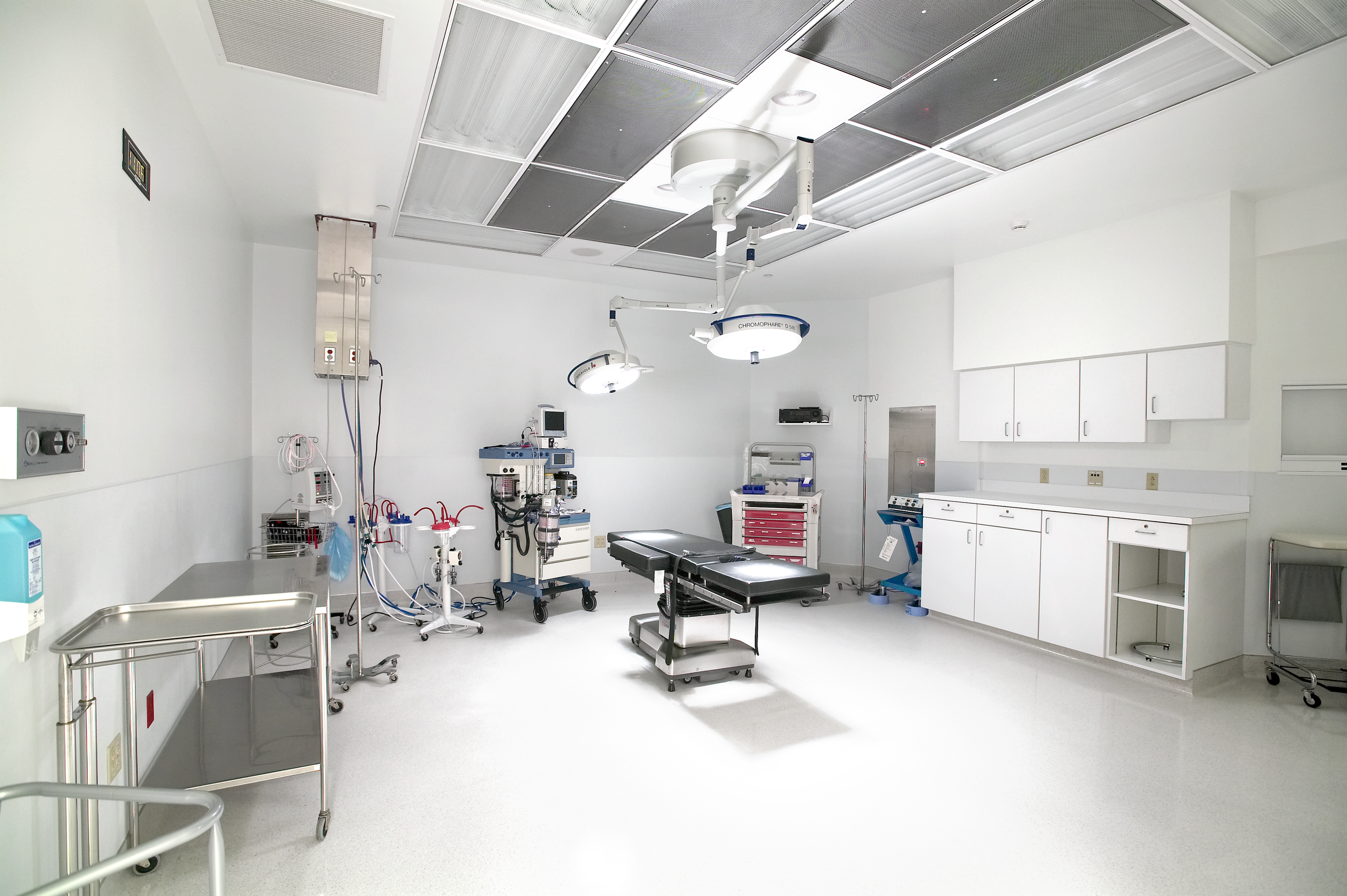 Interior of a new operating room in a hospital healing environment with clean bright finishes.