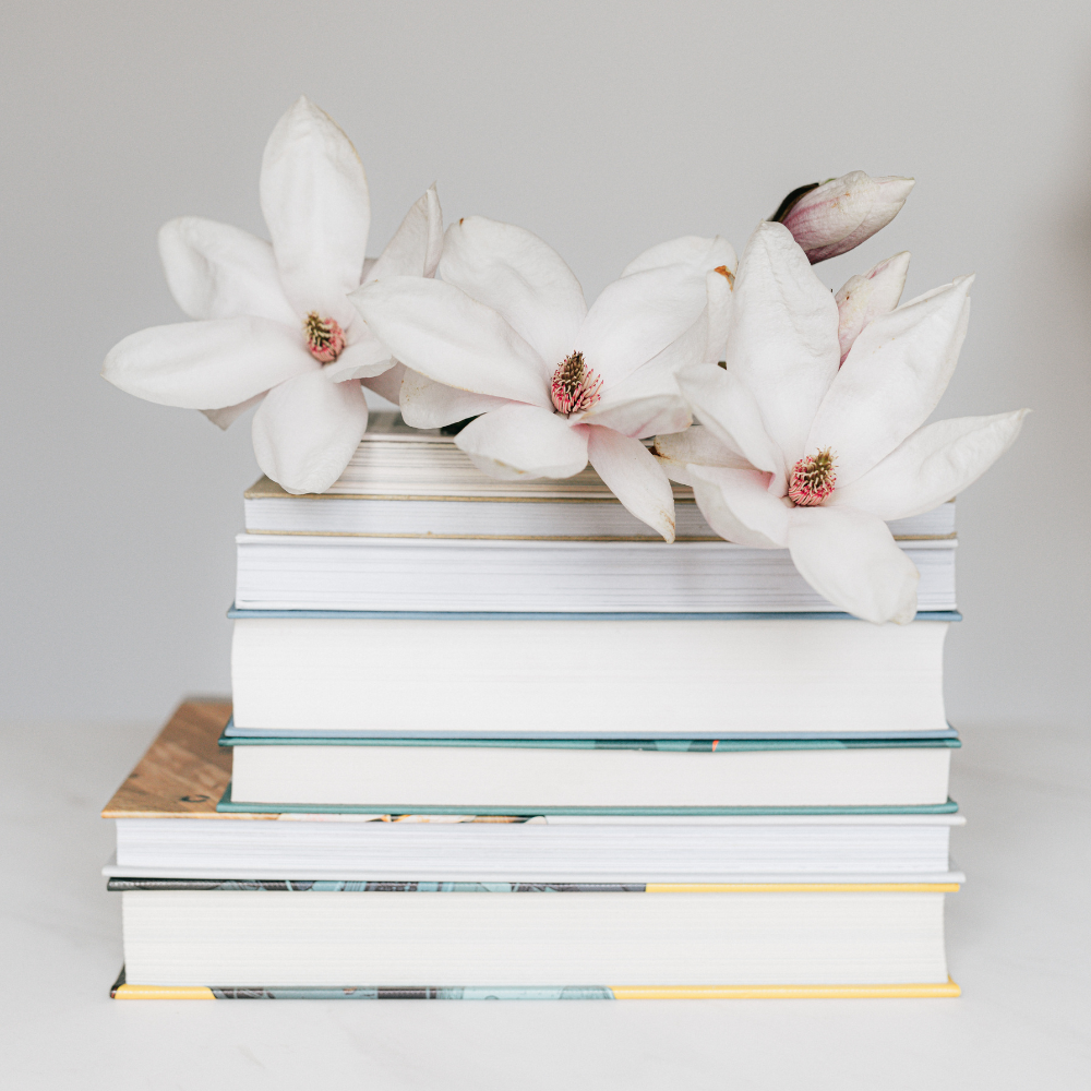Stack of books with flowers on top