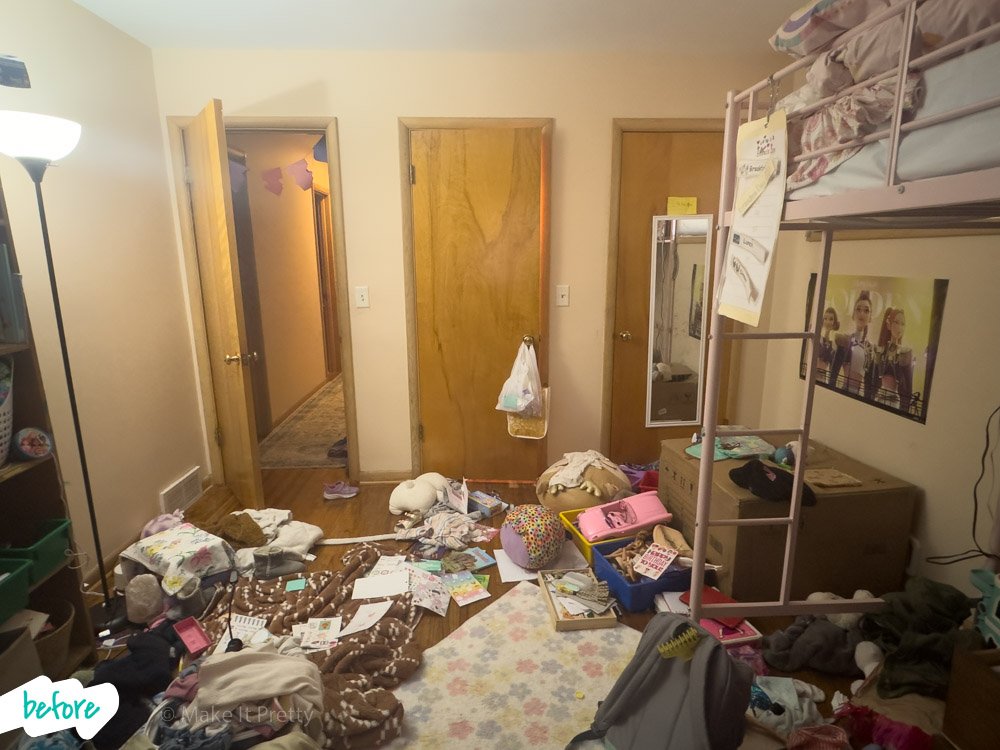 A cluttered bedroom with clothes and books scattered on the floor, a bunk bed with items on top, and open closet doors.