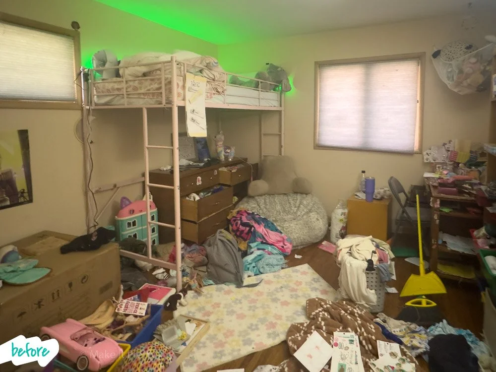 A cluttered bedroom with a loft bed, a chair with plushies, disorganized shelves, and various items scattered on the floor.