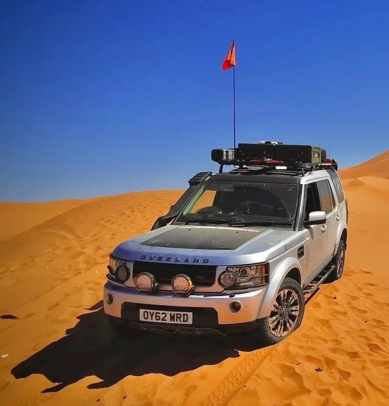 Tariq - Land Rover Discovery 4 proudly parked in Saharan sand dunes with Lucas and Mirinda