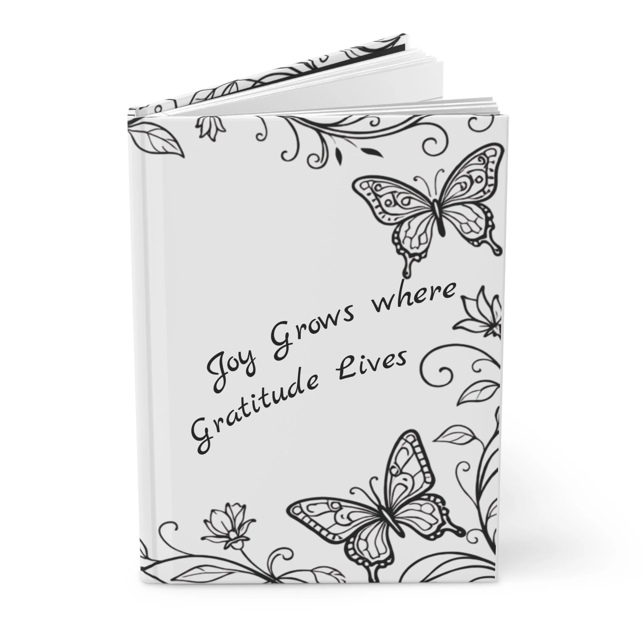 Black and white coloring book with floral and butterfly designs.