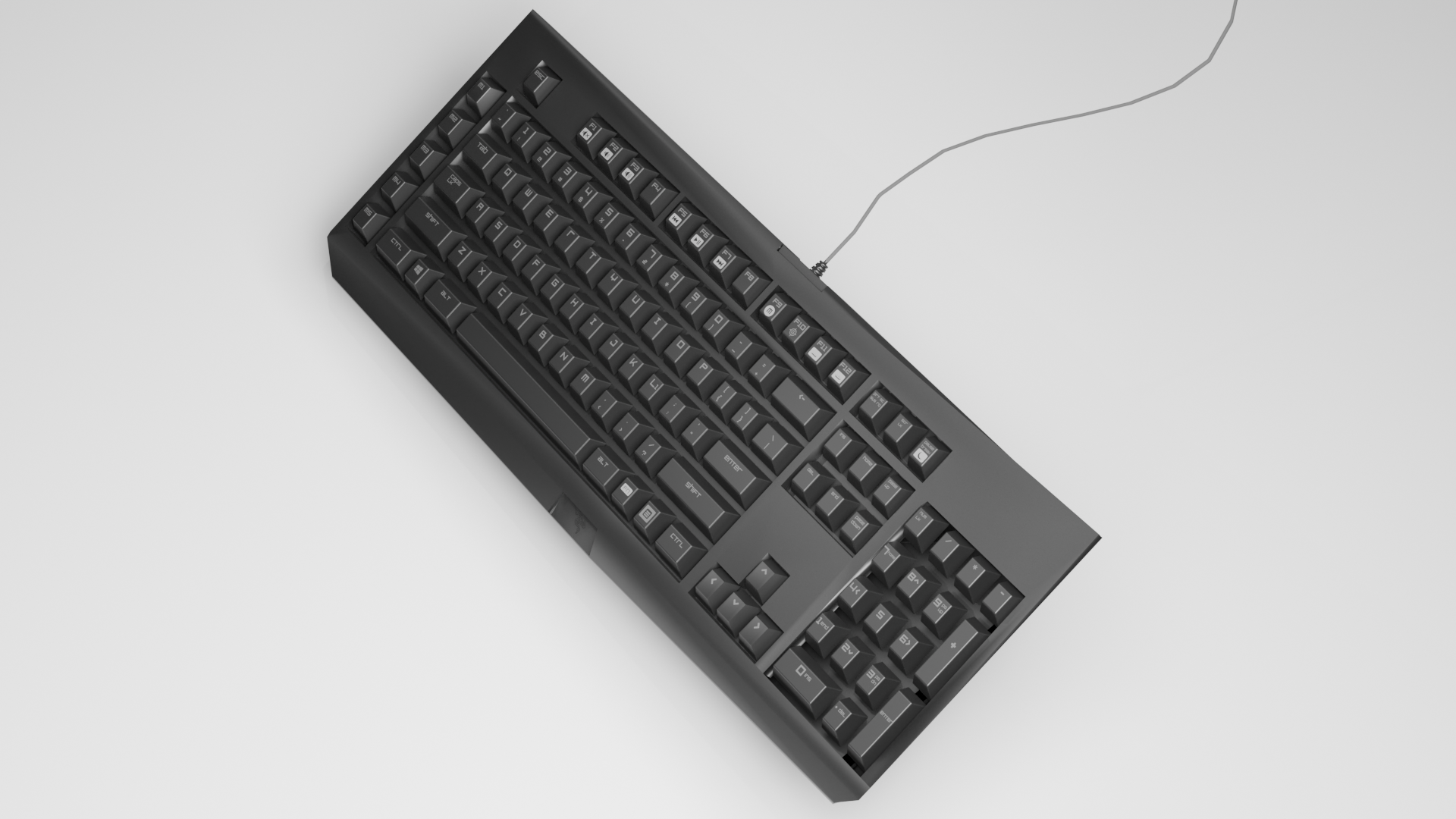 Black computer keyboard on a light surface with connected gray wire.