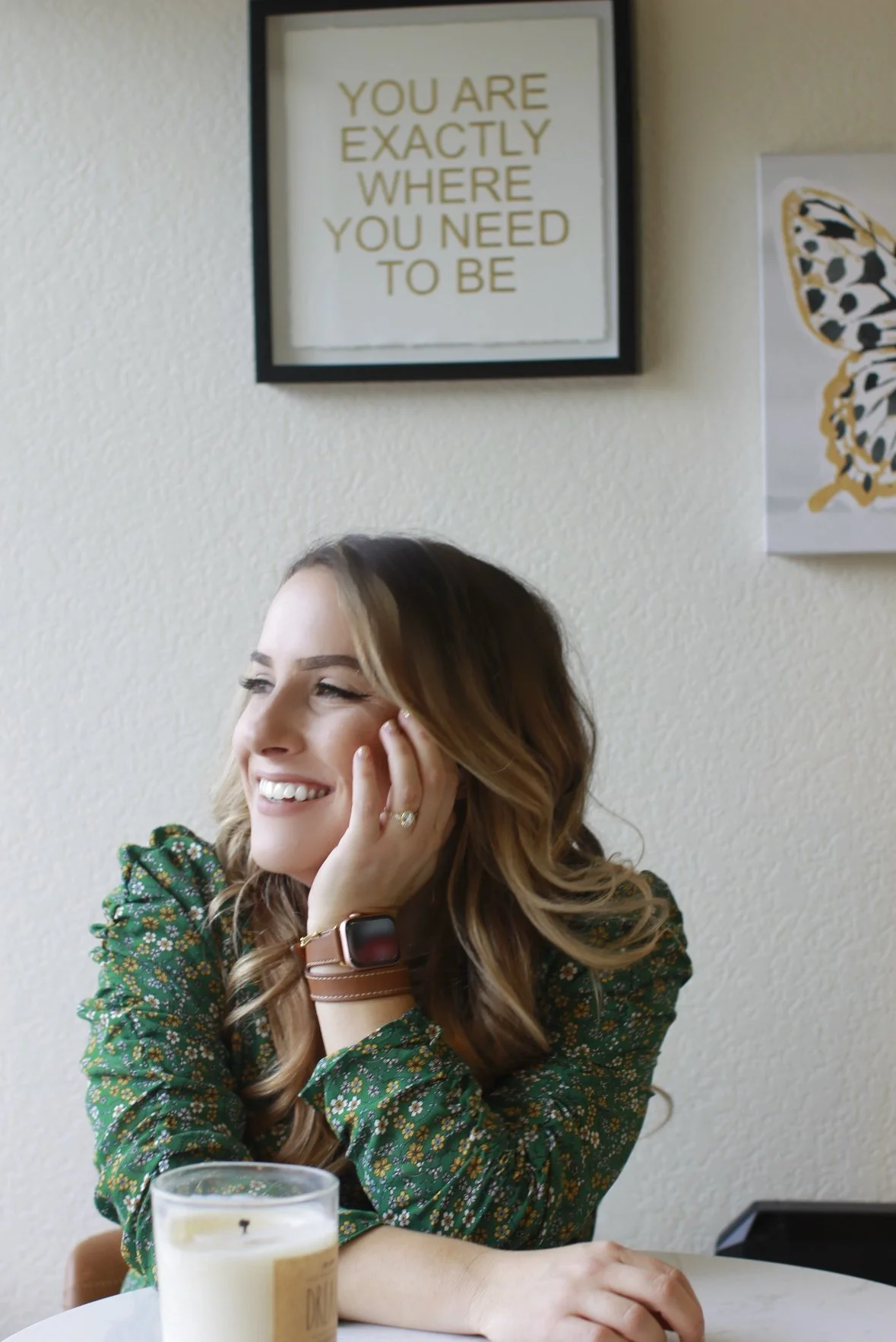 Jennifer Viscidy LMFT, psychotherapist at Alive Within Therapy & Wellness in El Dorado Hills, California, smiling thoughtfully by a window with a motivational sign reading “You are exactly where you need to be.”