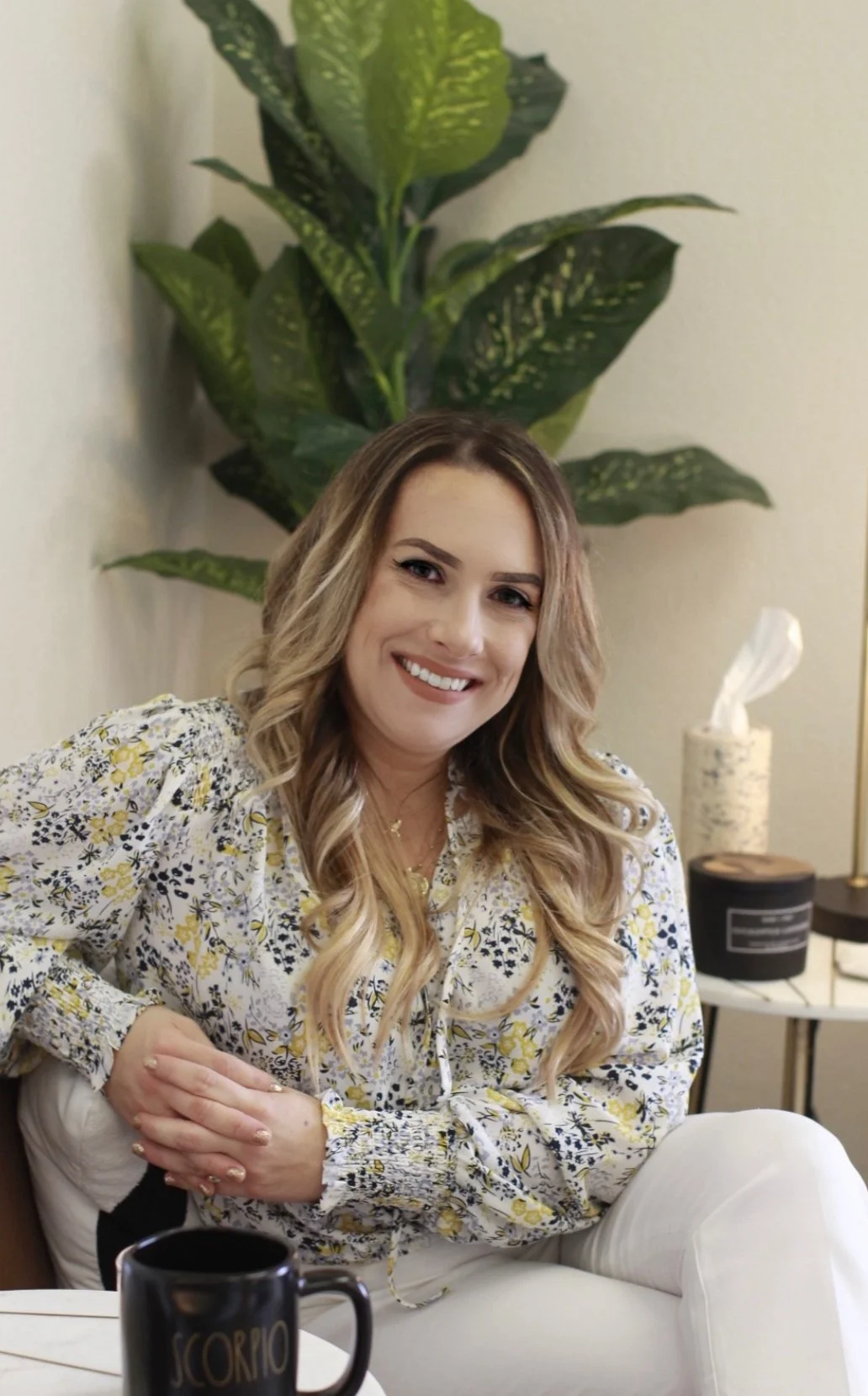 Jennifer Viscidy LMFT, psychotherapist at Alive Within Therapy & Wellness in El Dorado Hills, California, smiling in her office surrounded by calming décor and green plants.
