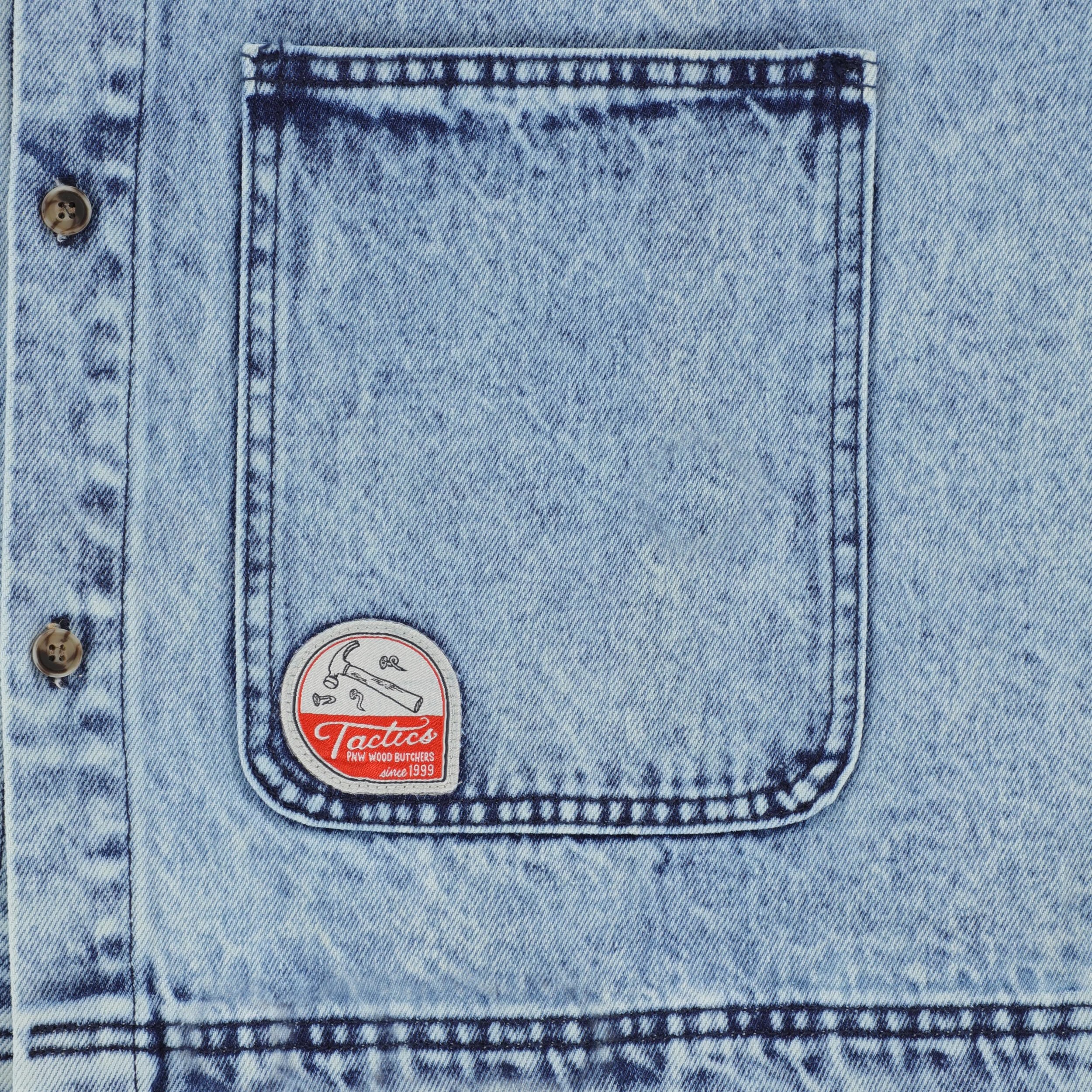 Organic-shaped teardrop label featuring misused nails on Denim Chore Shell Spring 2024