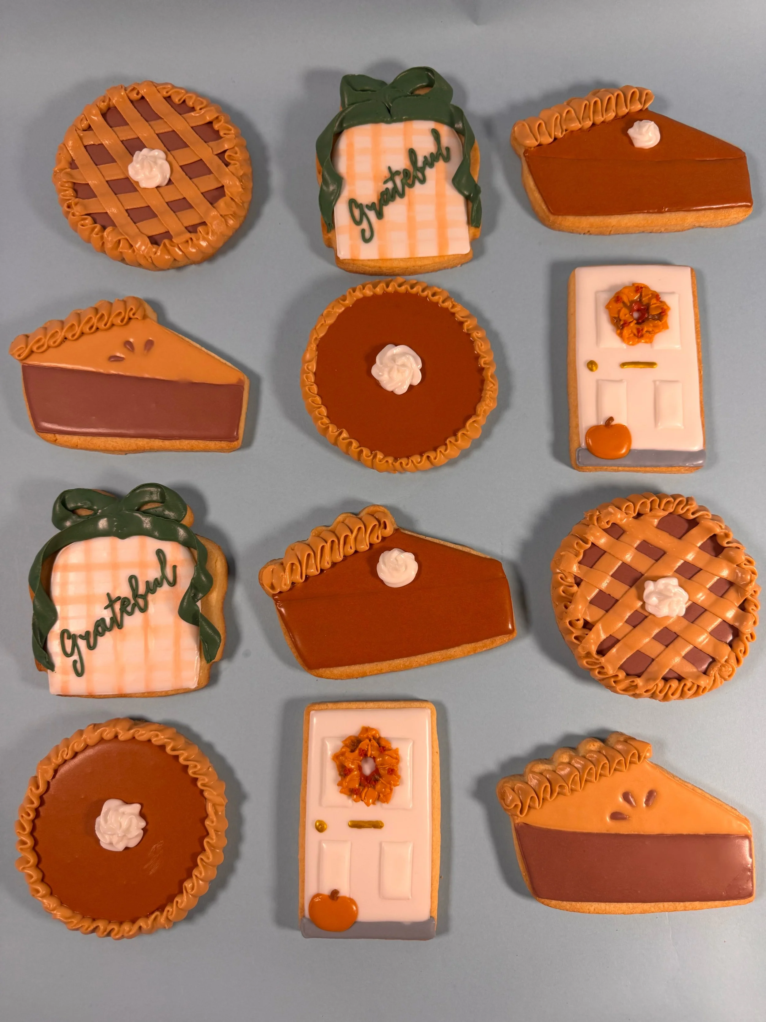 Decorative thanksgiving custom cookies with various designs, including lattice, pie, and holiday-themed motifs