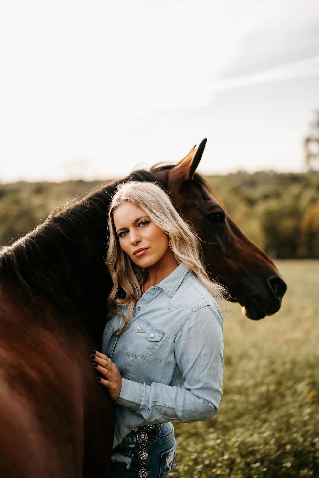 Girl wearing a cowboy hat with sunset in the background